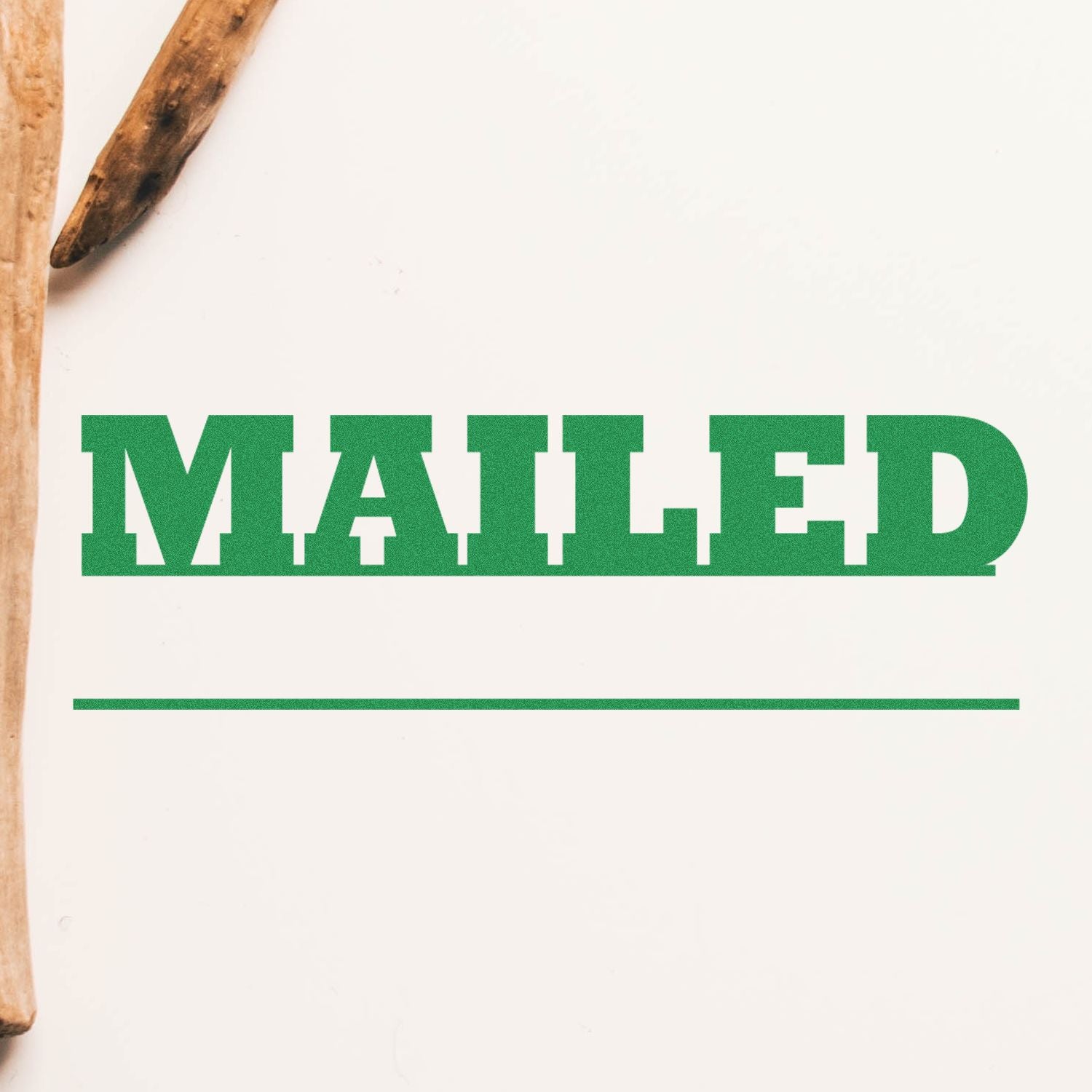 Green MAILED stamp on white paper, business mail delivery concept with wooden pencils in frame