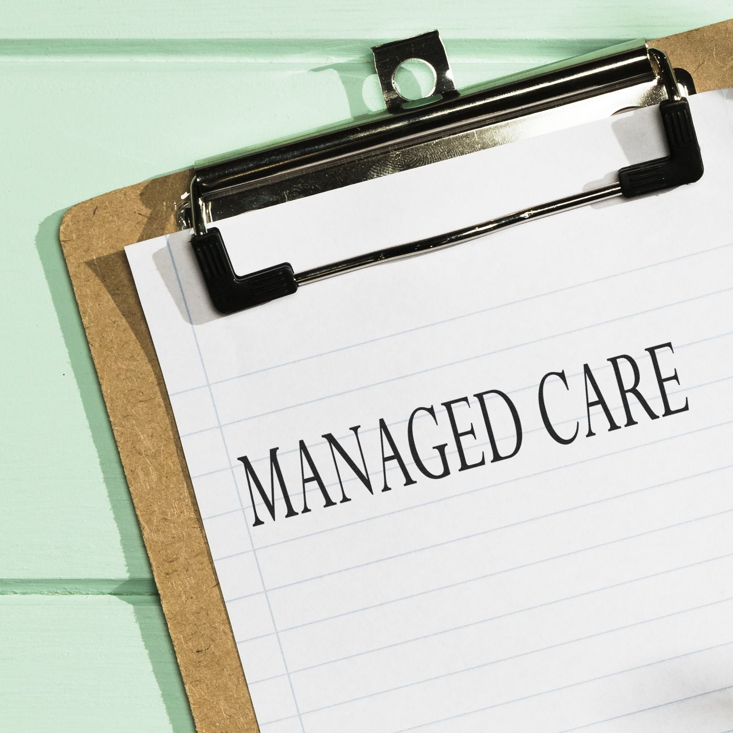 Clipboard with paper marked Managed Care, representing healthcare managed care management services.