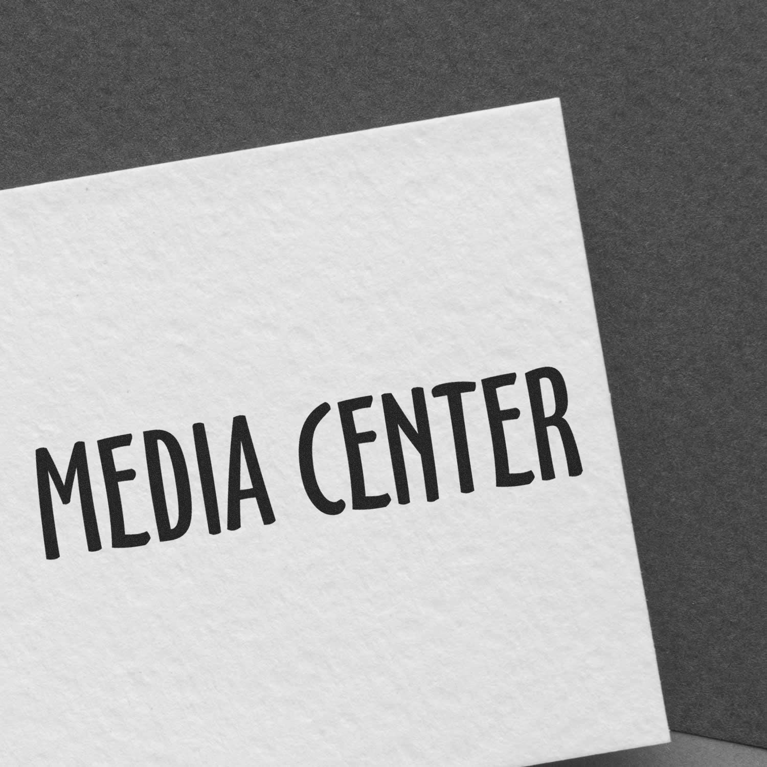 White paper on gray background with bold MEDIA CENTER text, indicating a media content hub or communications center.