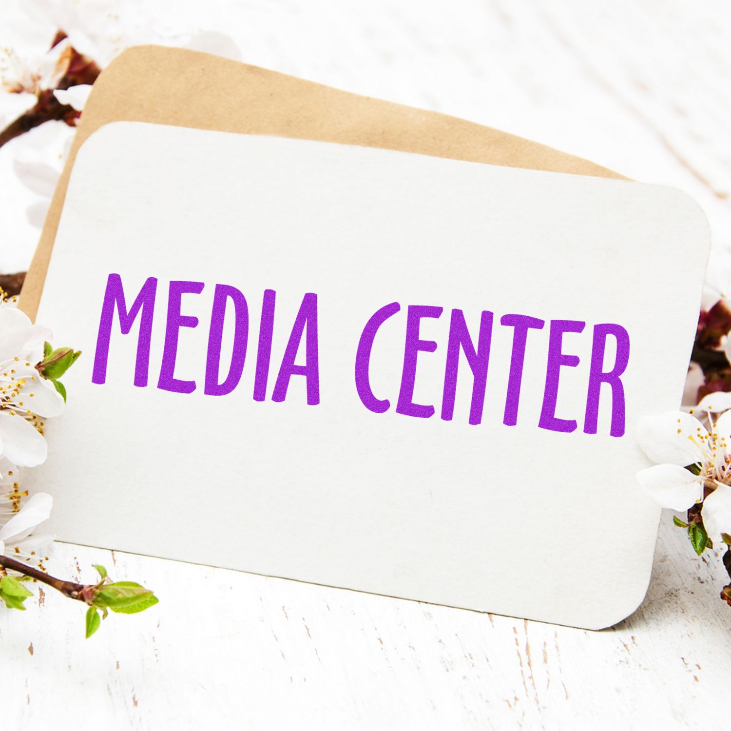 Wooden sign that reads MEDIA CENTER surrounded by spring flowers, promoting media center services and information.