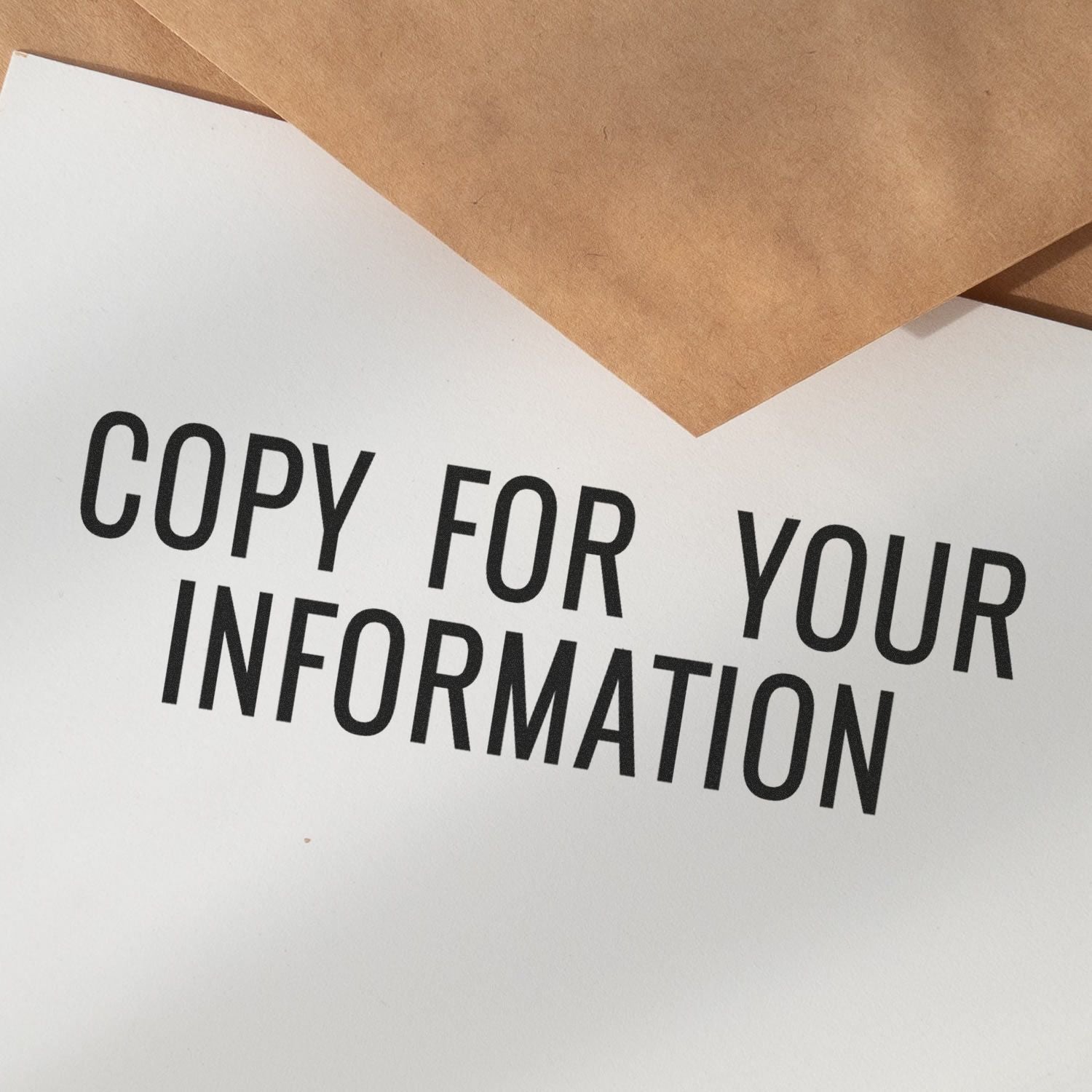 Close-up of a printed office document reading Copy for Your Information with brown envelopes on top.