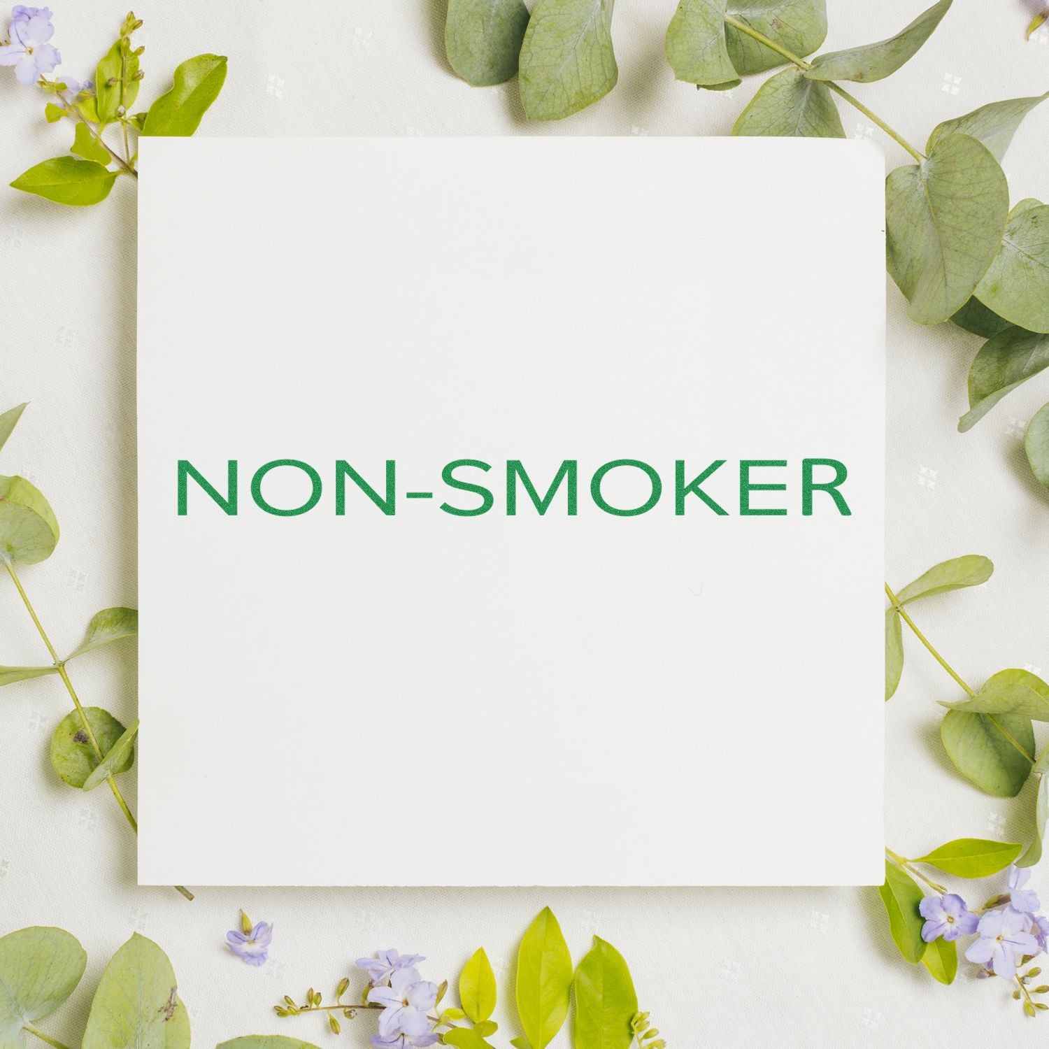 Non-smoker smoke-free label on blank card with green leaves and flowers, ideal for healthy lifestyle or workplace signage