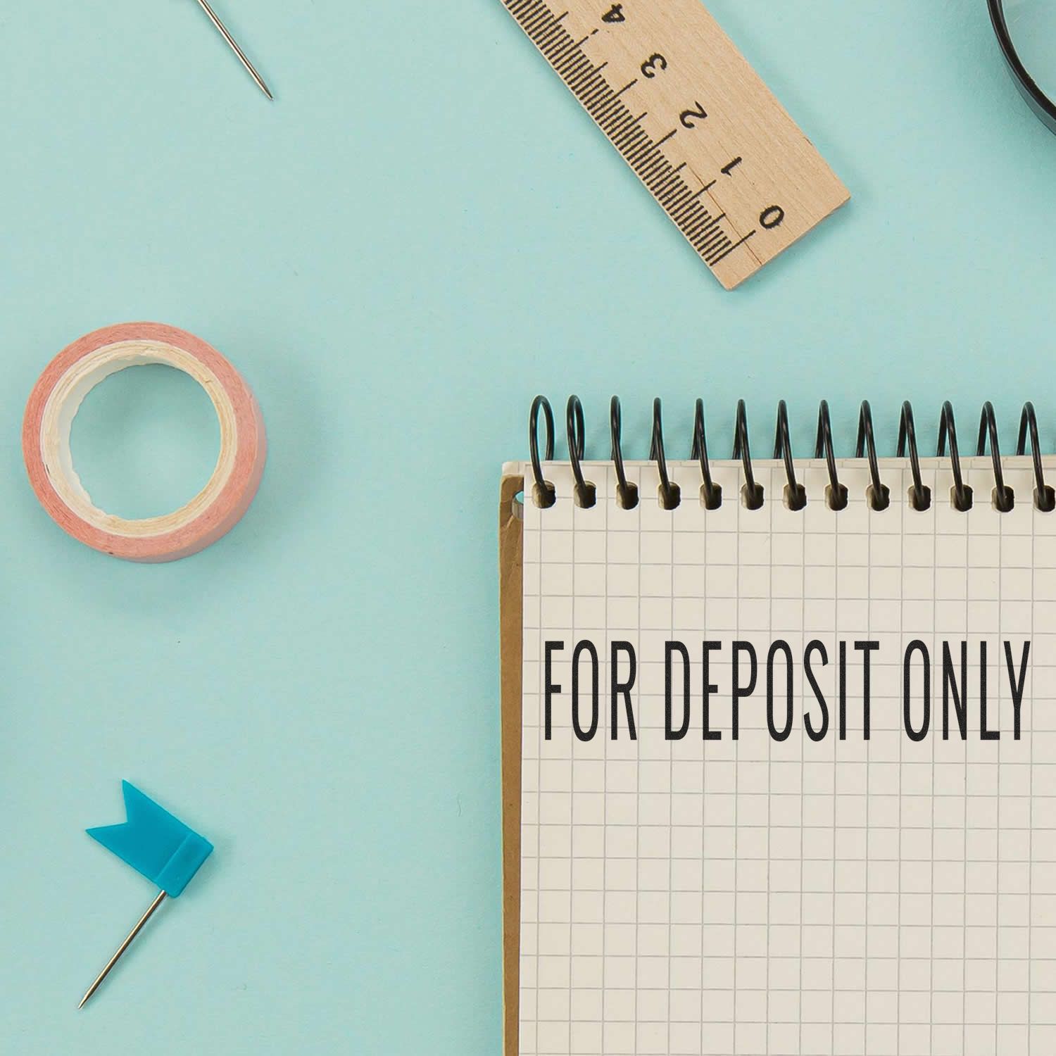 Bank deposit only concept: notepad stamped FOR DEPOSIT ONLY with ruler and pins on office desk