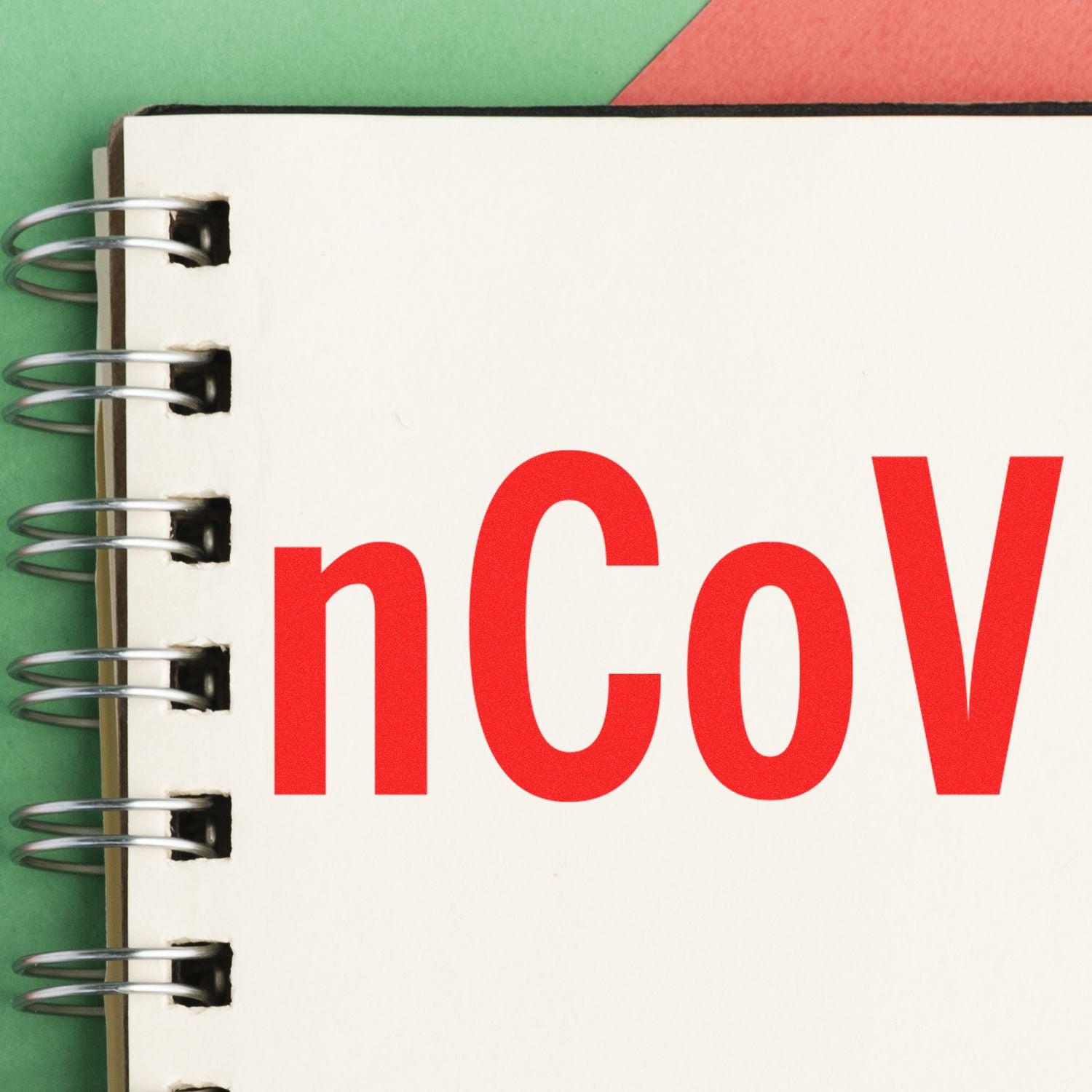 Spiral notebook page showing nCoV text, representing coronavirus information and COVID-19 awareness study.