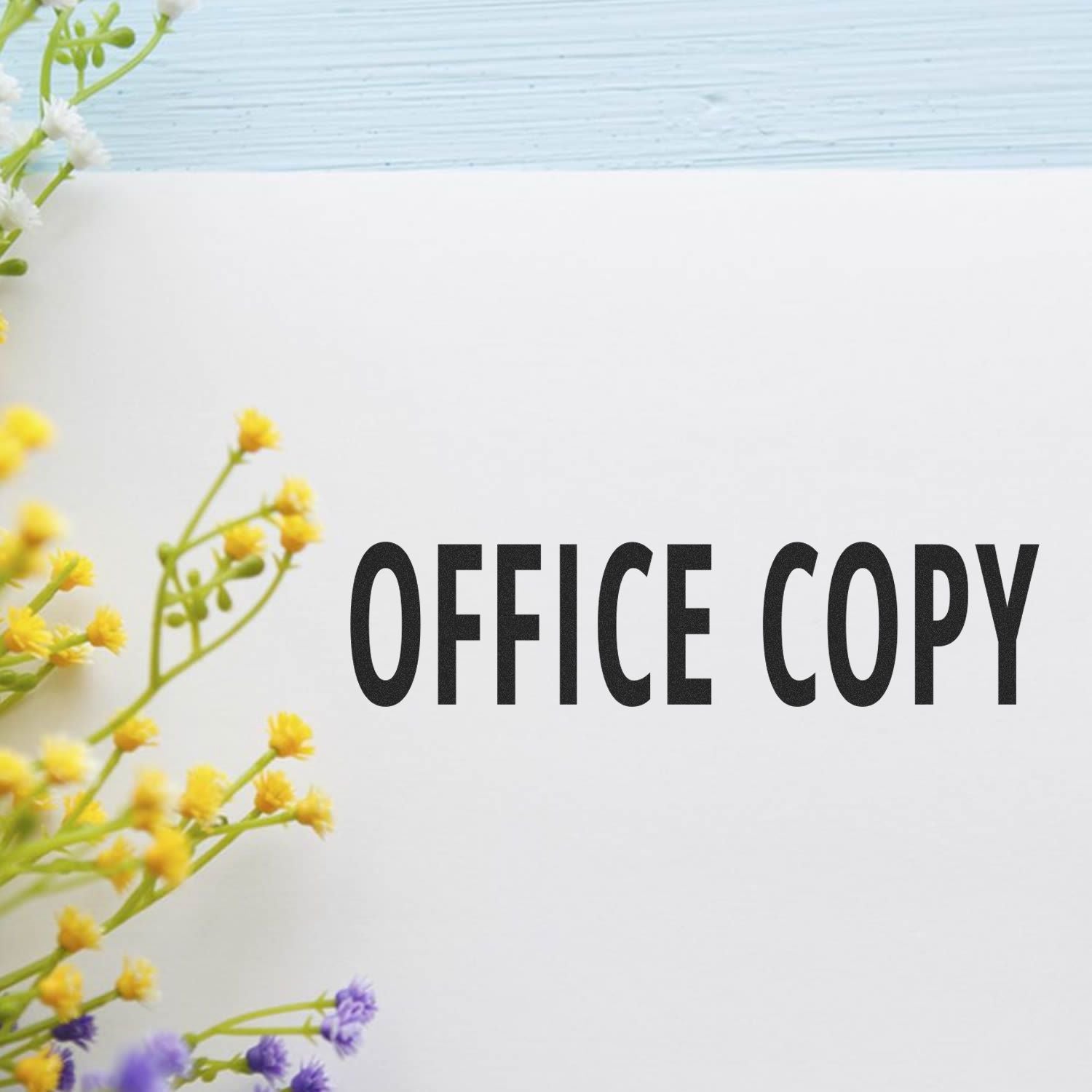 Fresh yellow flowers with OFFICE COPY branding on a white background for office copy printing paper