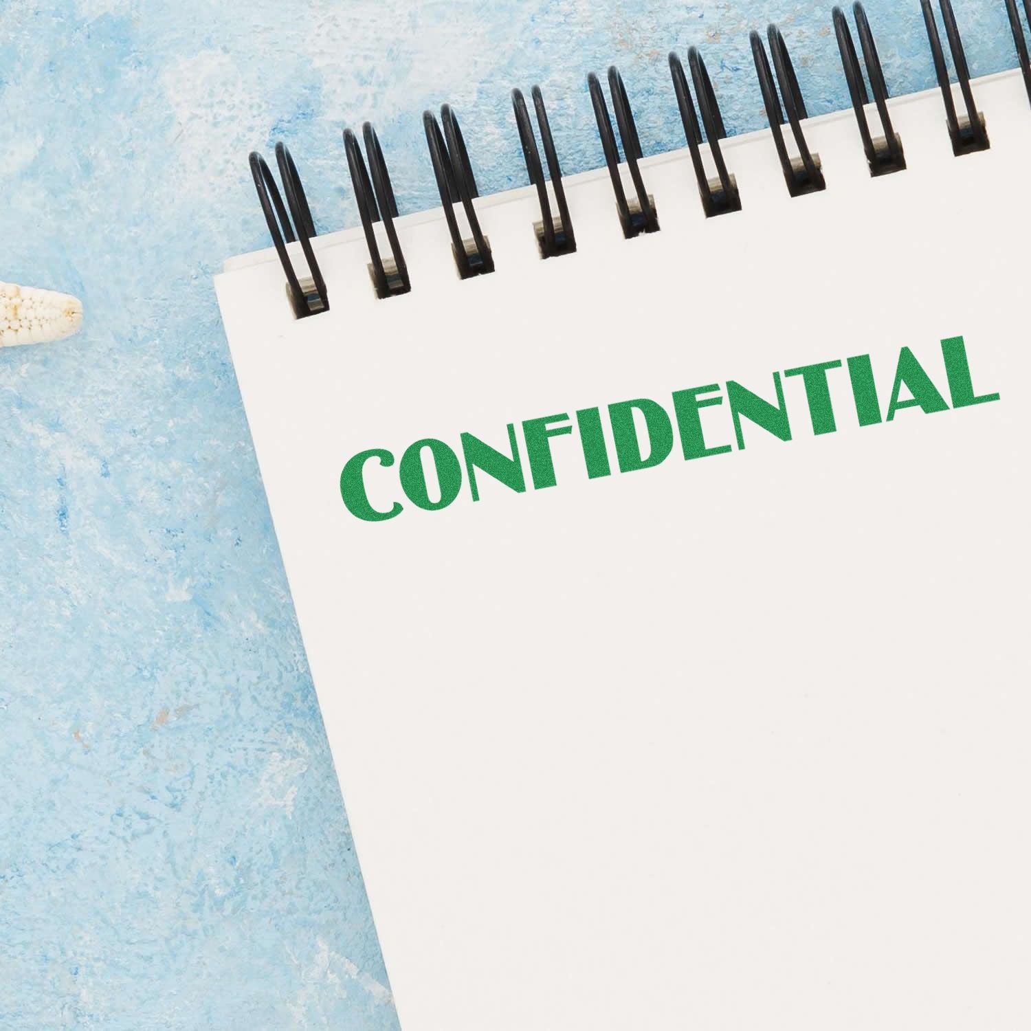 Confidential document label on pinned paper with black binder clips, emphasizing privacy and data security.