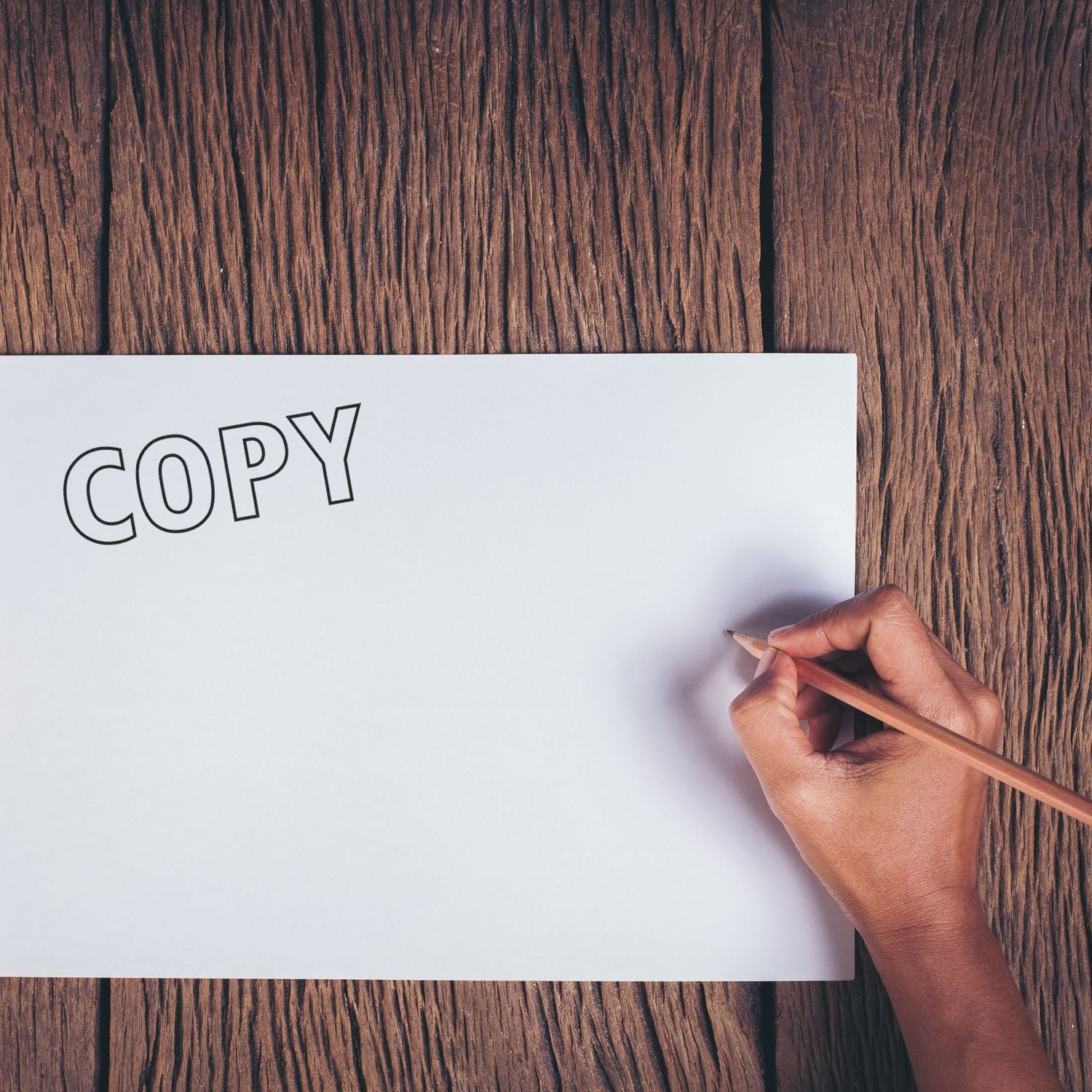 Hand writing COPY on blank paper over wooden desk, representing copywriting and content creation for marketing, branding strategy.