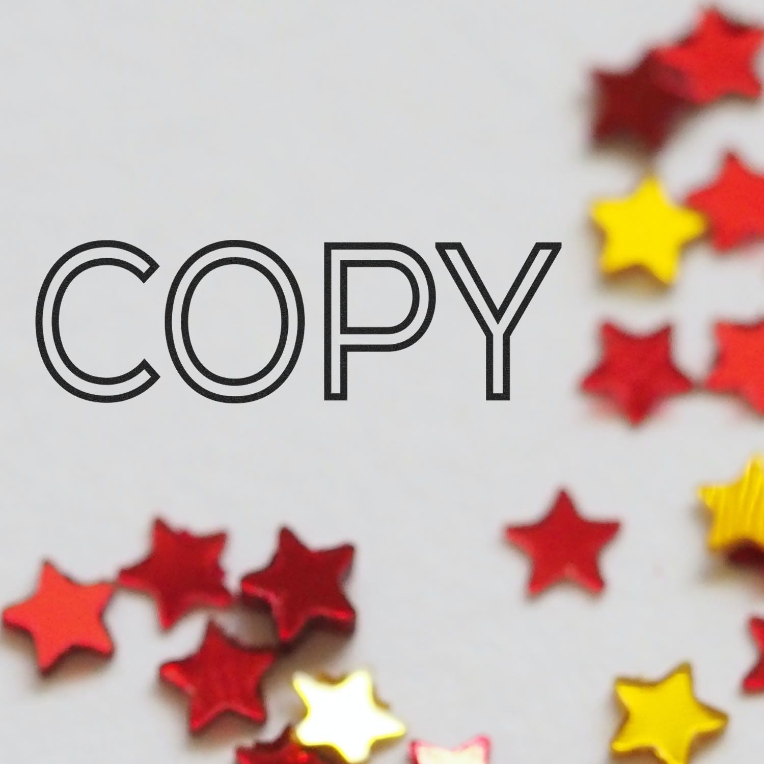 COPY text with colorful red and yellow star confetti on a white background