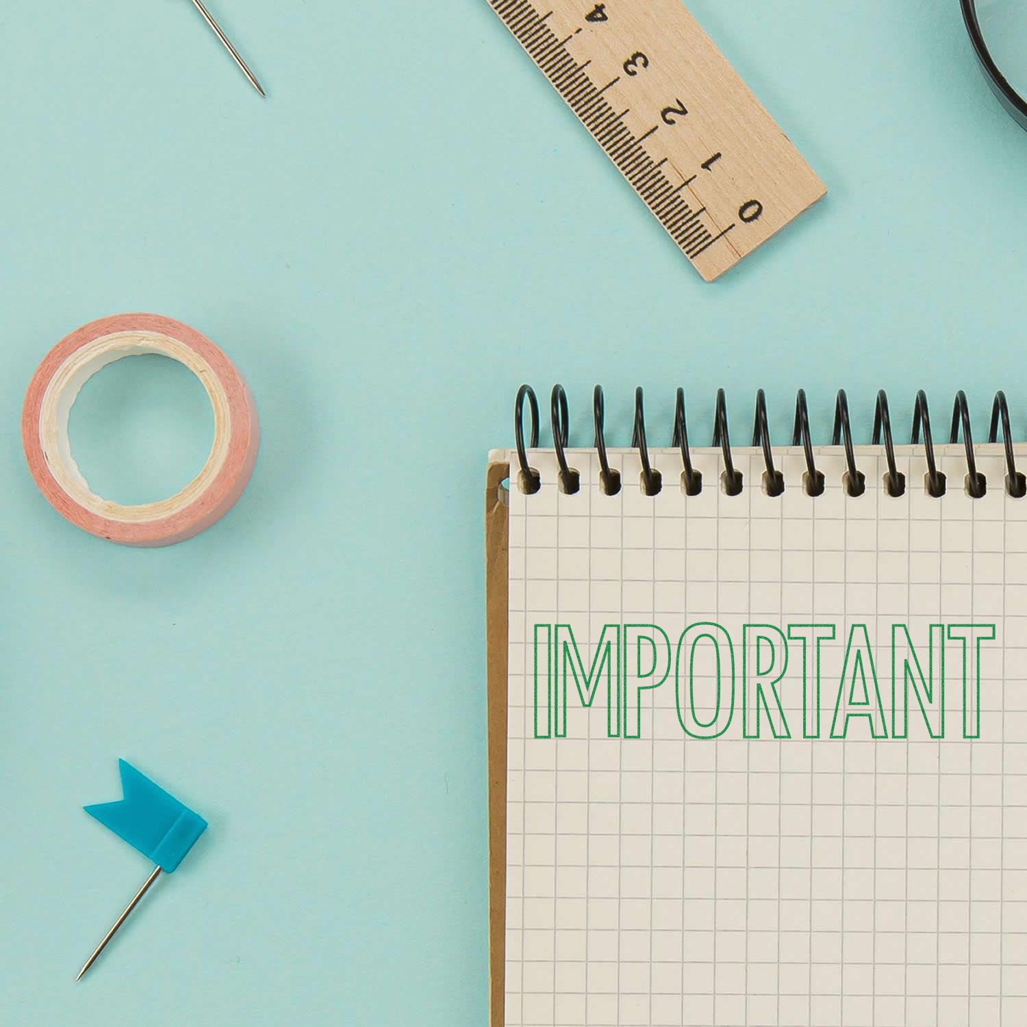 Office desk supplies with tape, pins, ruler, and notebook showing IMPORTANT for productivity and planning.