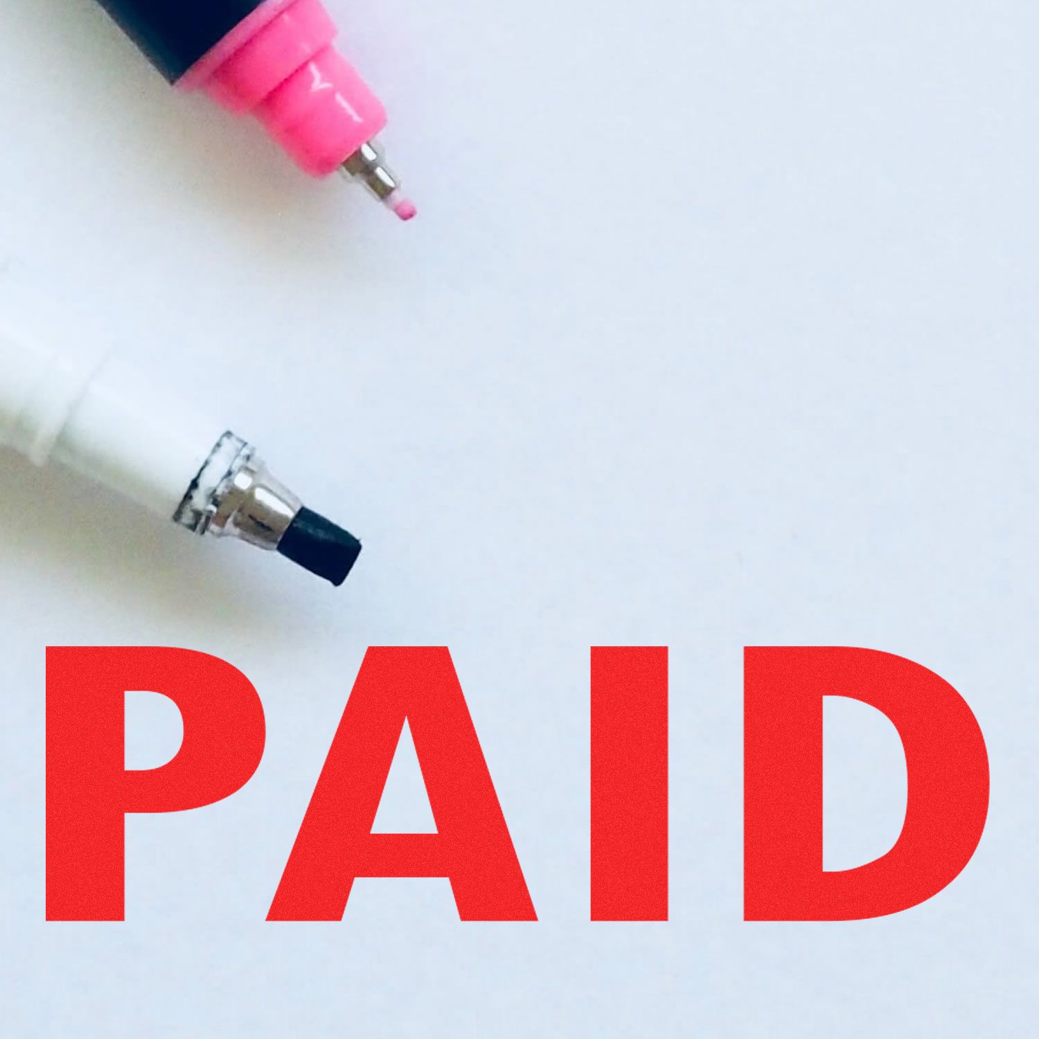 Electric bill paid concept with electrical plug and adapter above large red PAID lettering