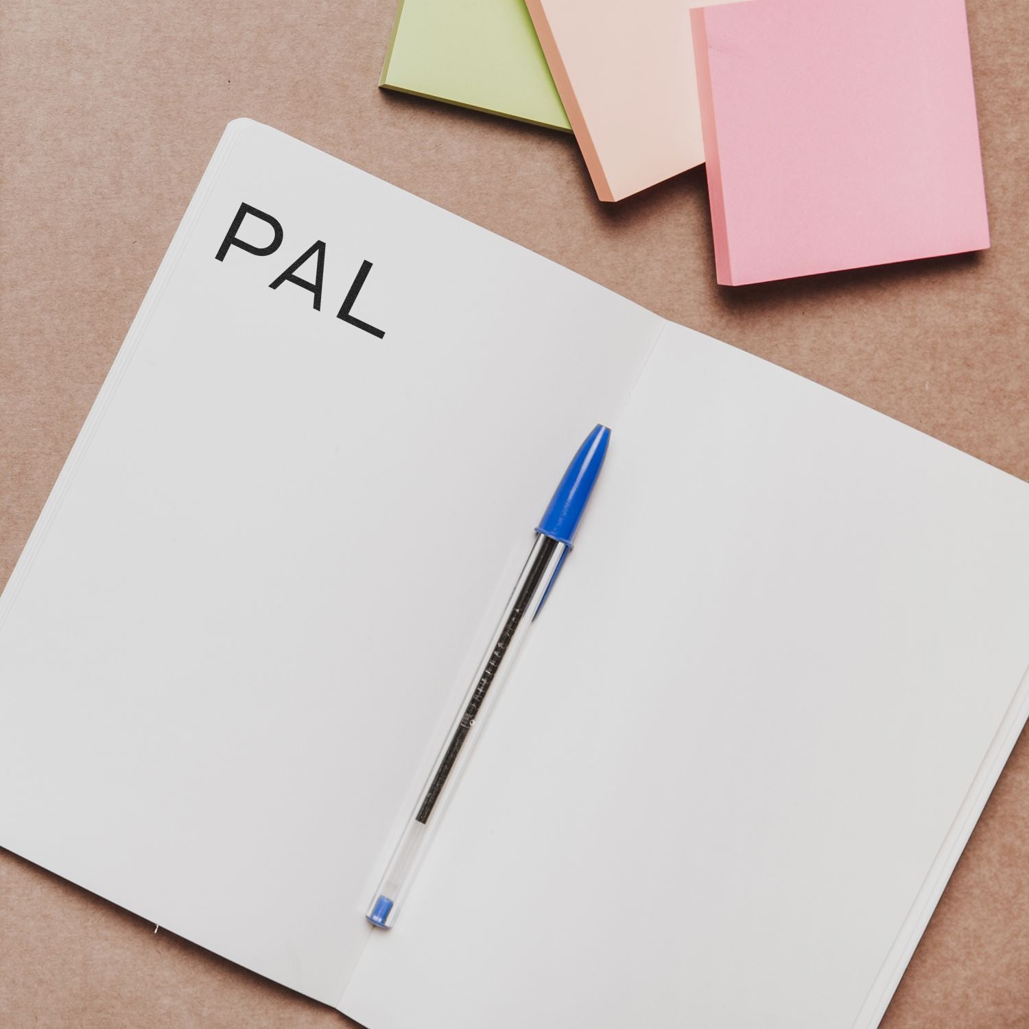 FAIL lettering on a white notebook with blue pen and colorful sticky notes, symbolizing productivity and writing goals.