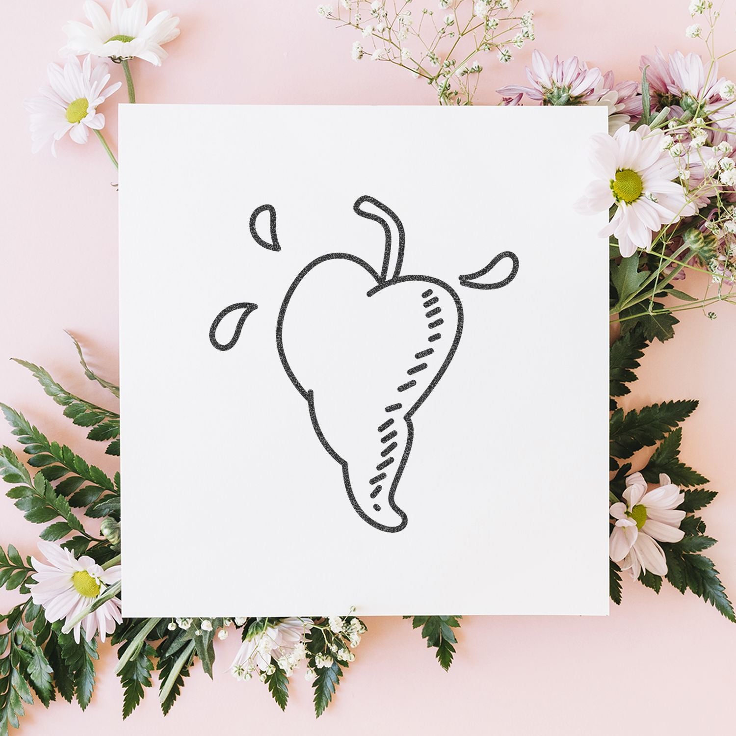 Pastel floral flat lay with a white card featuring a hand-drawn pear illustration, surrounded by pink daisies and greenery.