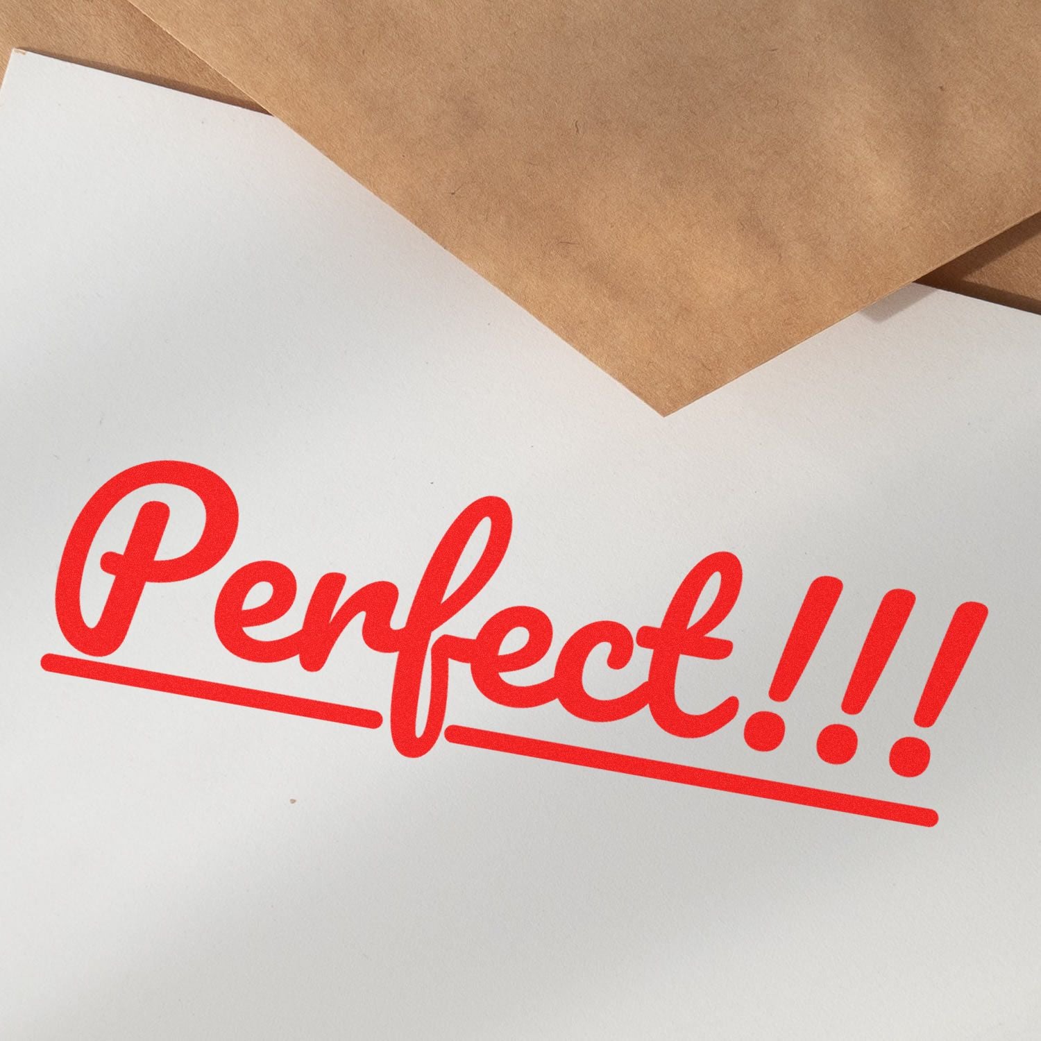 Penke!! branded packaging card with red hand-lettered logo on white paper and kraft brown cardboardclose-up product branding for gifts.