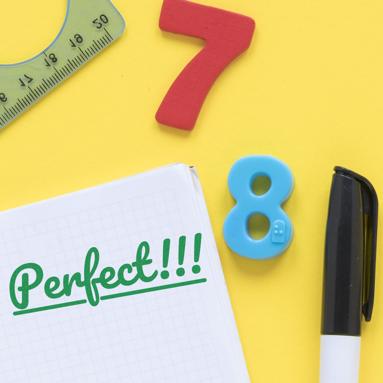 Stationery layout with wooden number 7 and blue number 8, pen, ruler, and notebook reading Perfect!!! for math homework for kids.