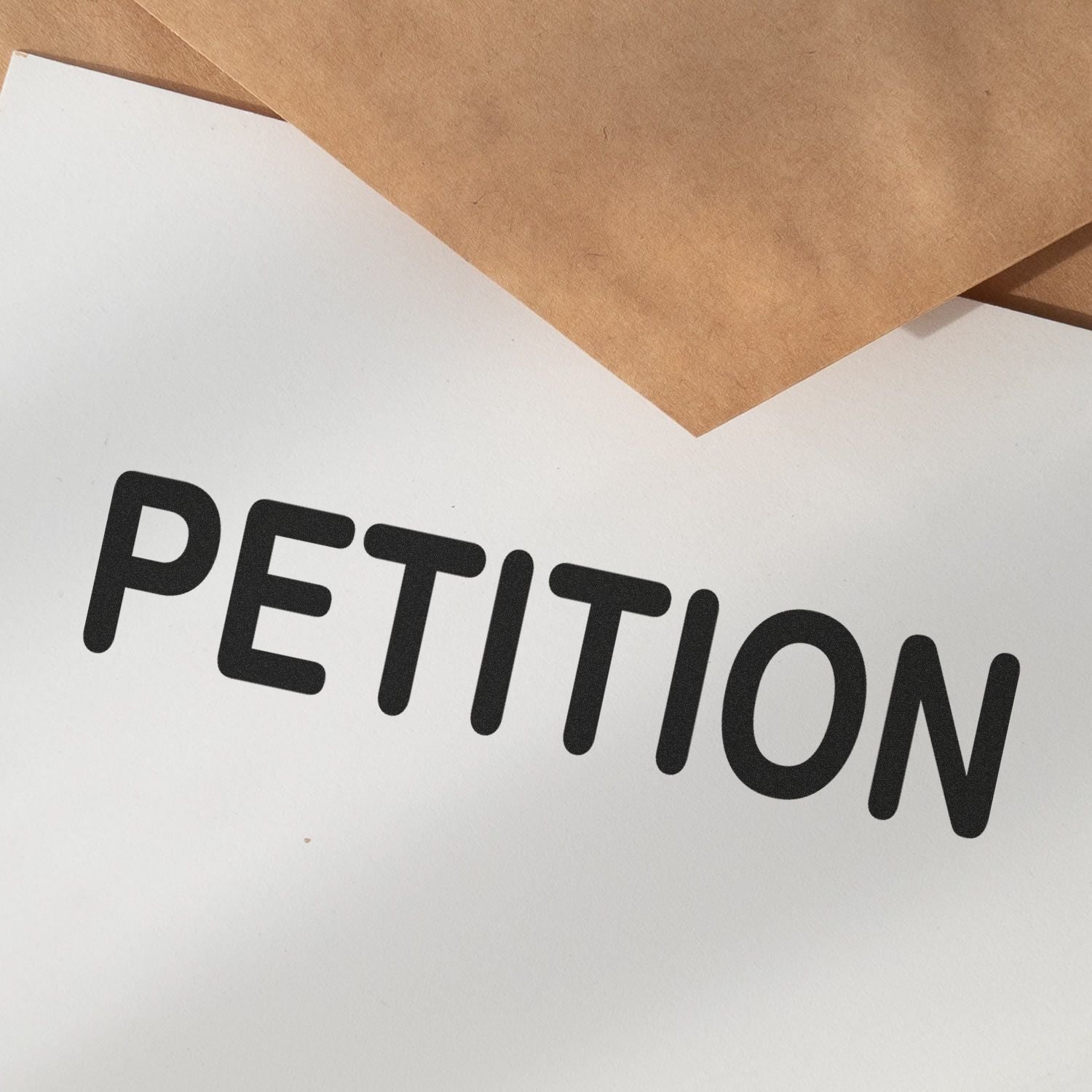 Petition headline on paper with cardboard backing, illustrating an online petition or public campaign call to action.
