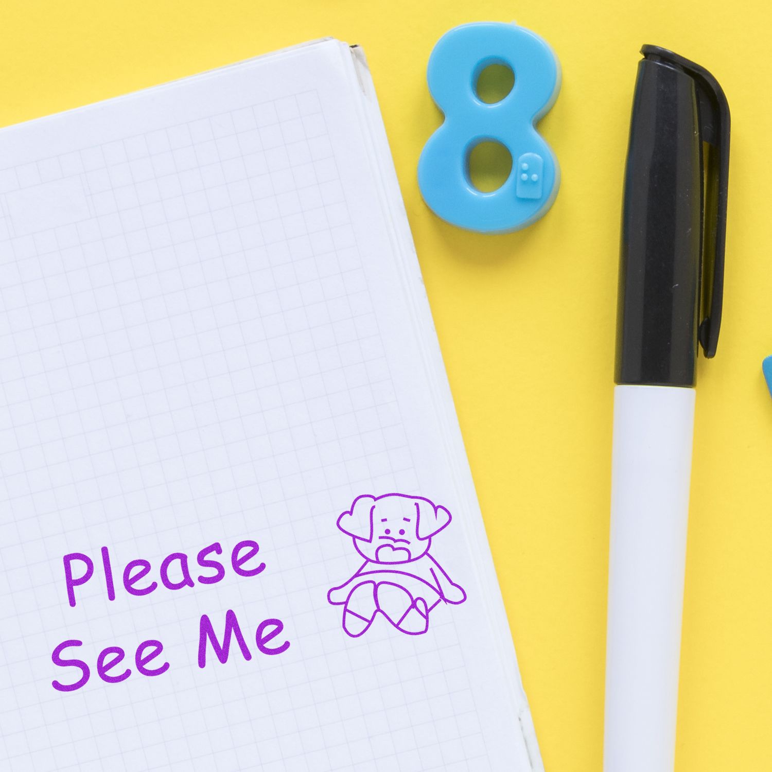 Notebook with Please See Me note, pen, and blue number 8 on yellow background.