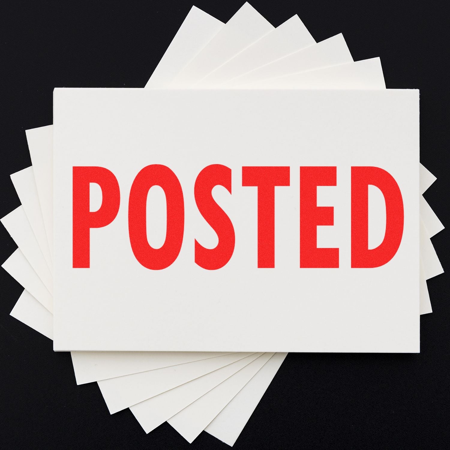 Stack of POSTED cards on black background, showing published status or announcement for marketing and social media updates online.