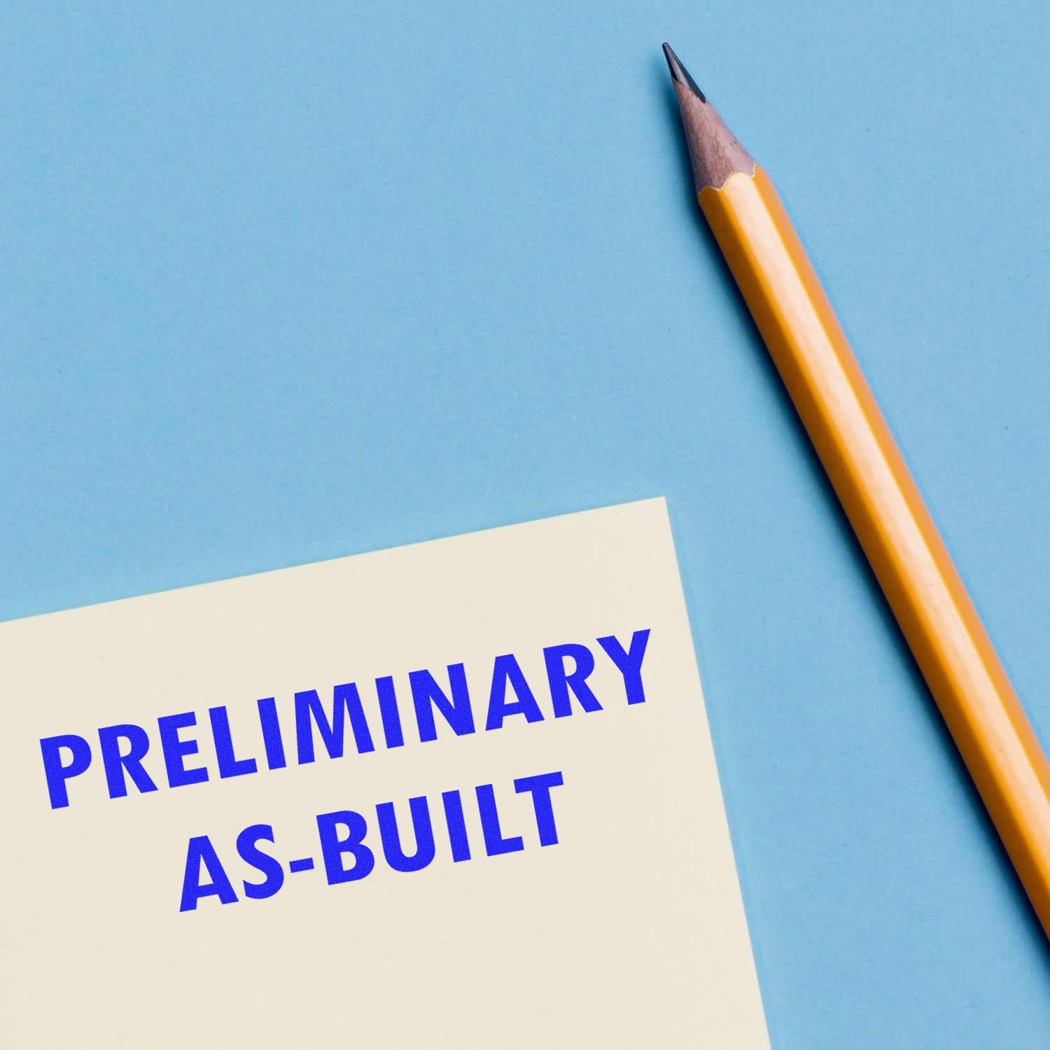 Preliminary as-built construction document with pencil on a blue background