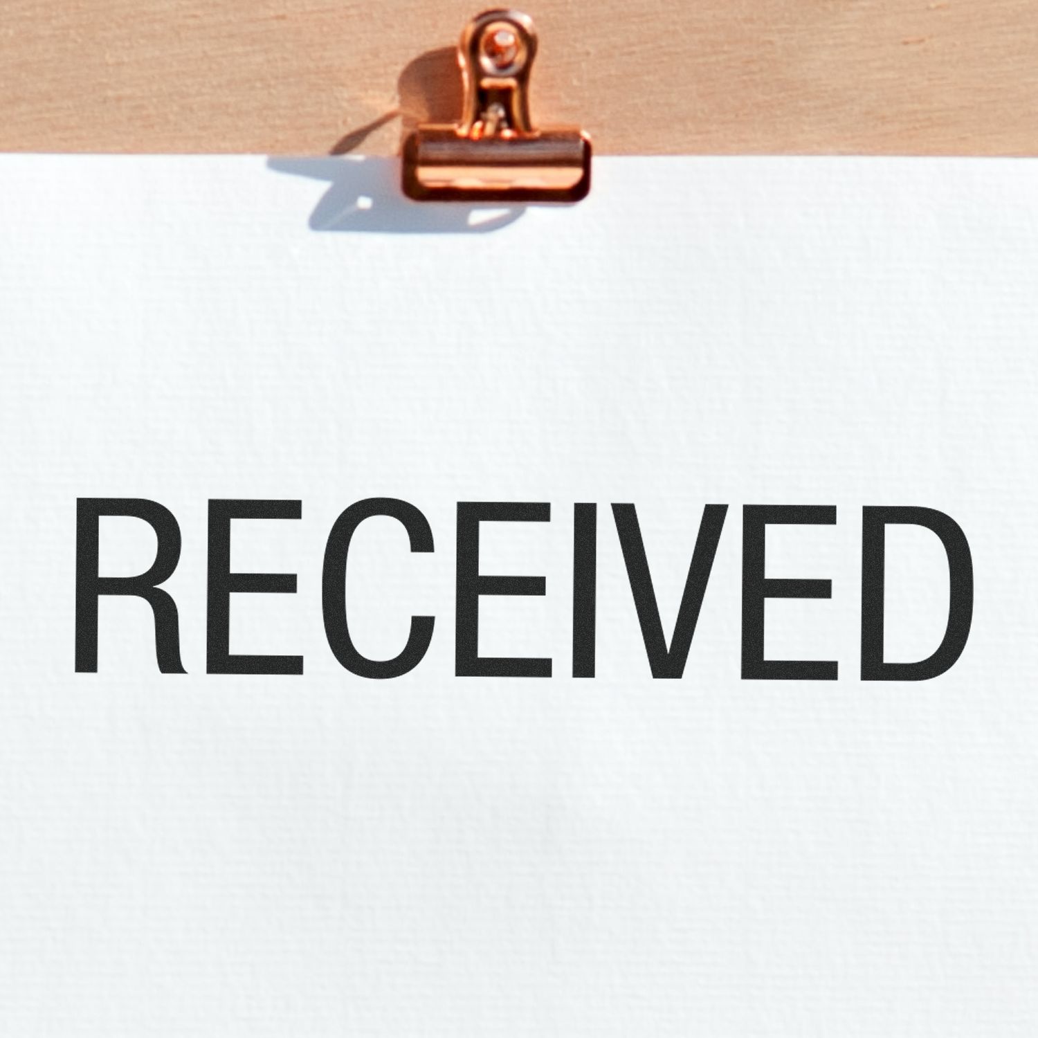 Clipboard with blank paper and large RECEIVED stamp, business document approval concept.