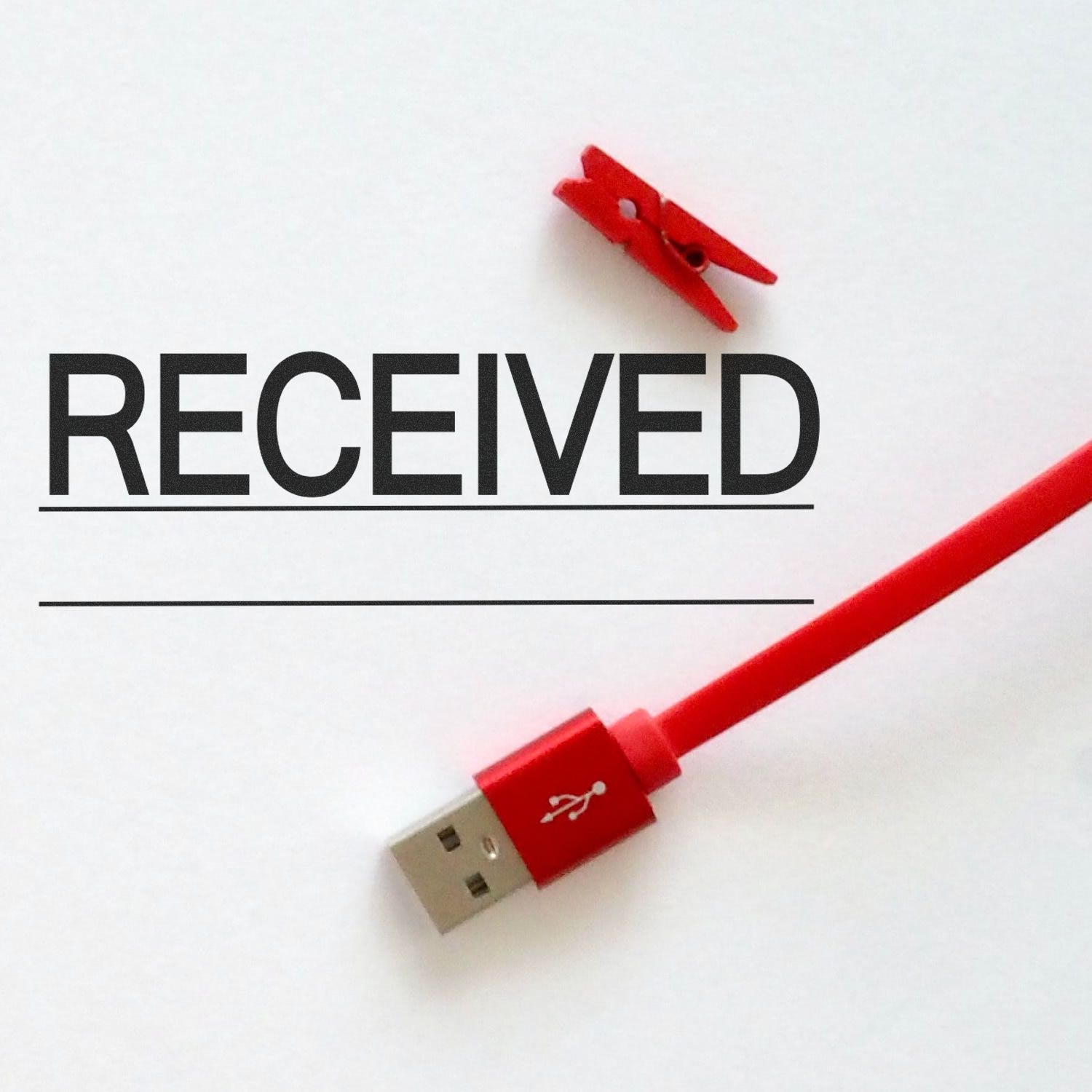 Red USB cable with clip and the word RECEIVED, symbolizing data transfer, file upload, or email receipt.
