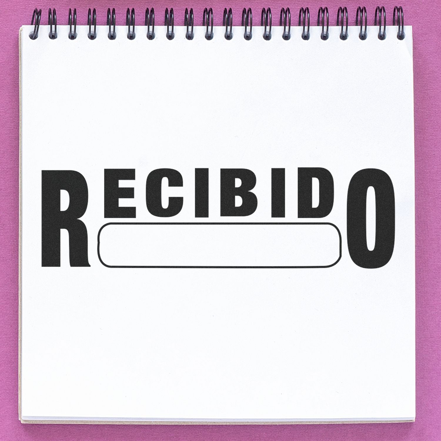 Spiral notebook page with RECIBIDO text on a pink background, receipt stamp concept.