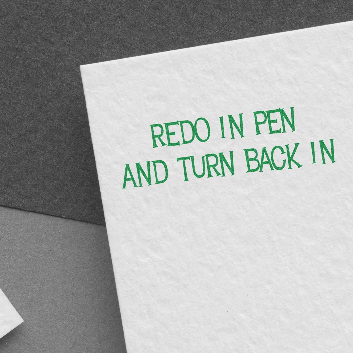 Instruction card stating Redo in pen and turn back in, for school resubmission and assignment correction.