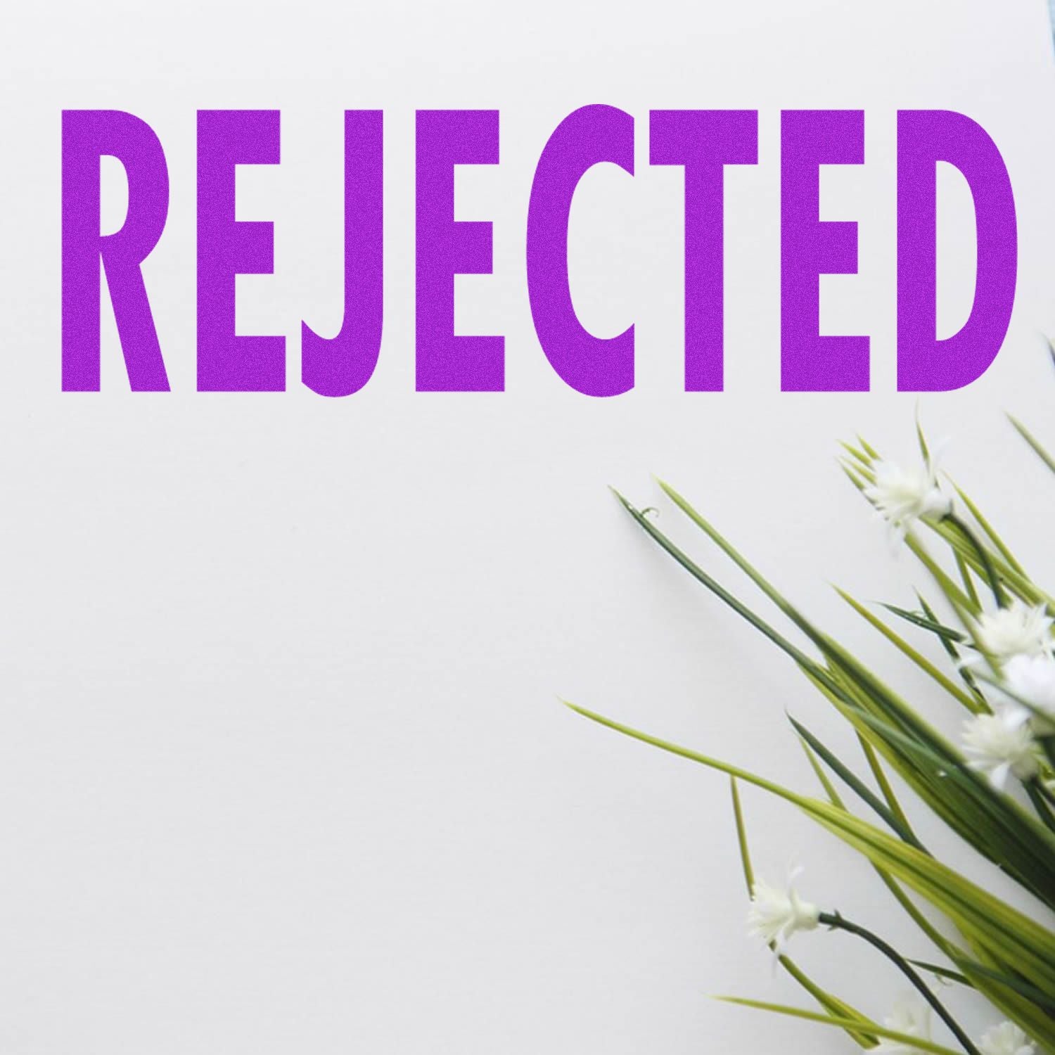Purple REJECTED stamp on white background with green floral accents in the corner