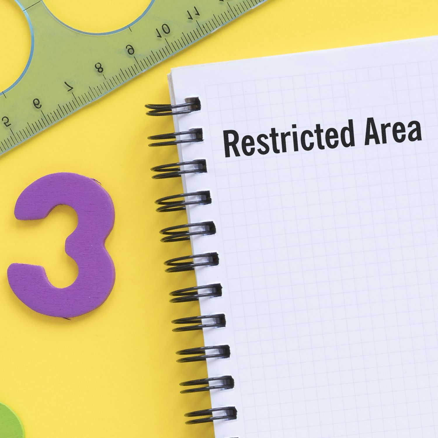 Notebook page reading Restricted Area with measuring ruler and question-mark icon, highlighting restricted safety zone concept.