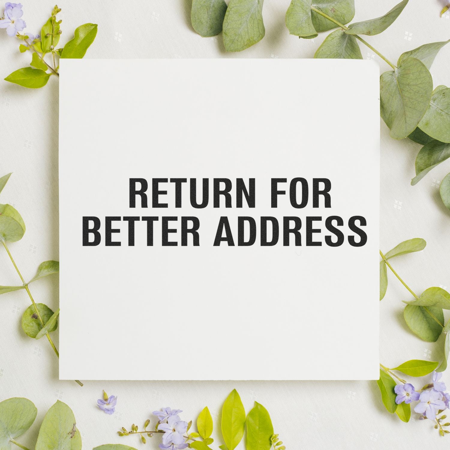 White Return for Better Address card with green eucalyptus leaves and small purple flowers on a floral background.