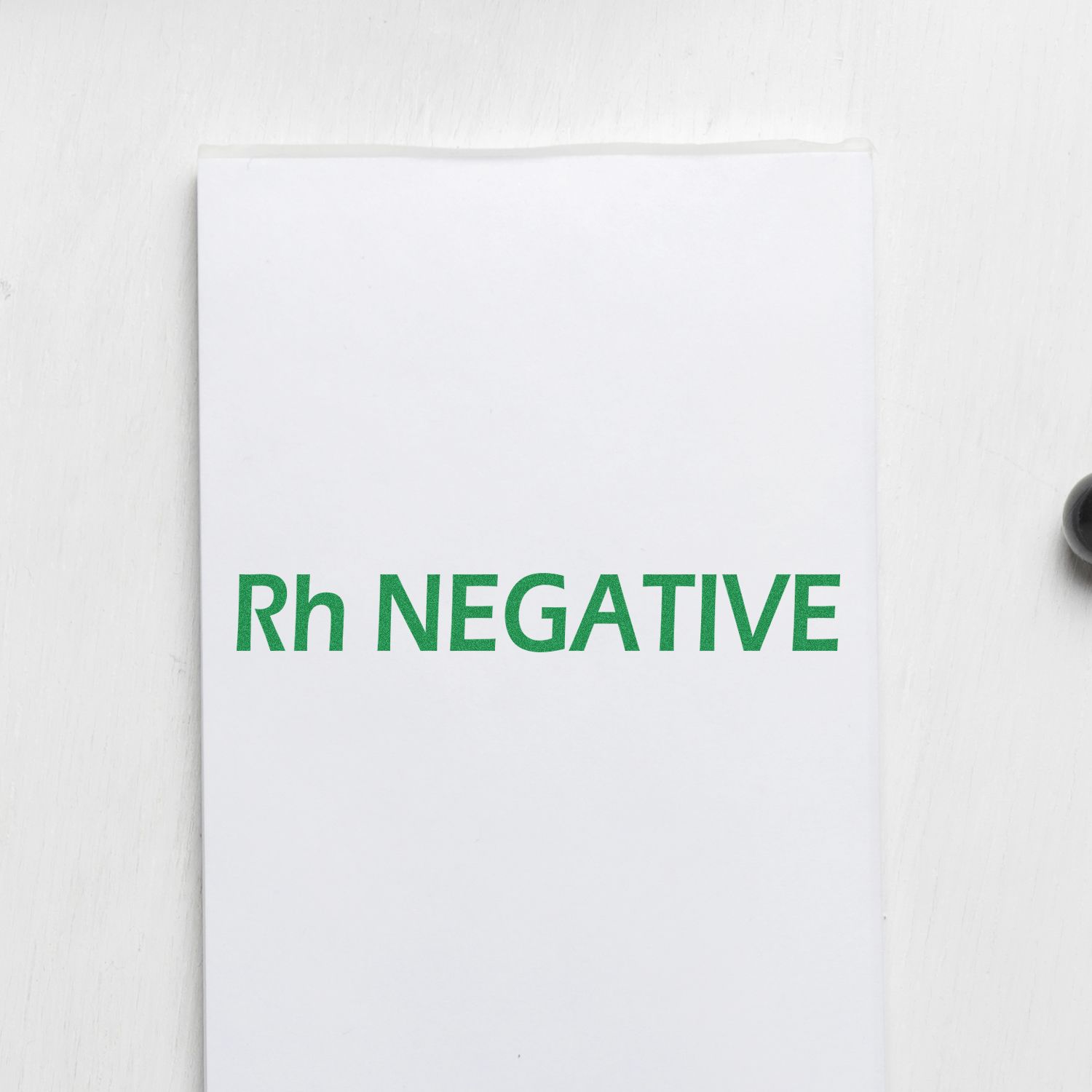 Rh-negative blood type label on white document, emphasizing Rh factor negative for medical transfusion compatibility details
