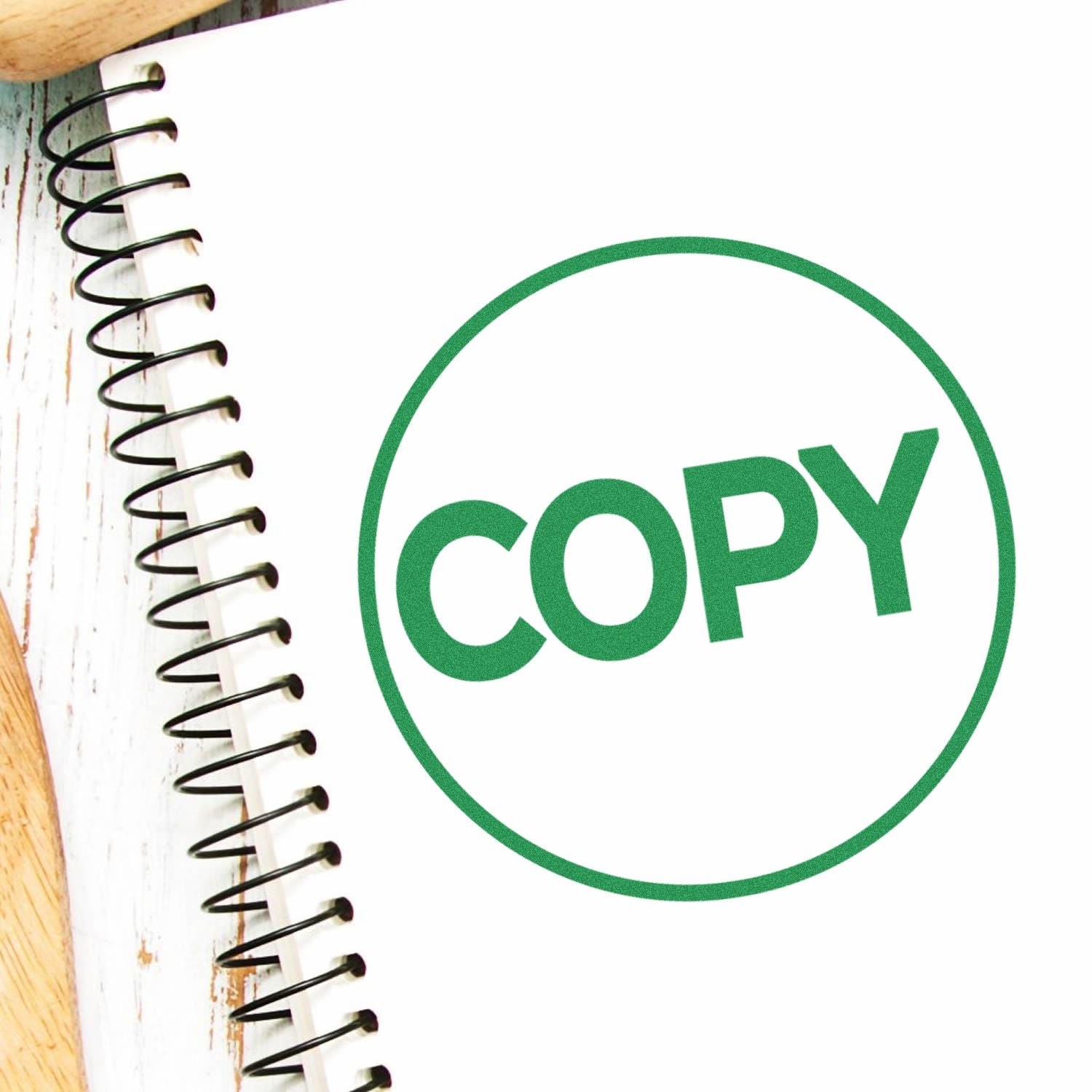 Green COPY icon on a spiral notebook page, representing content copying and copyright.