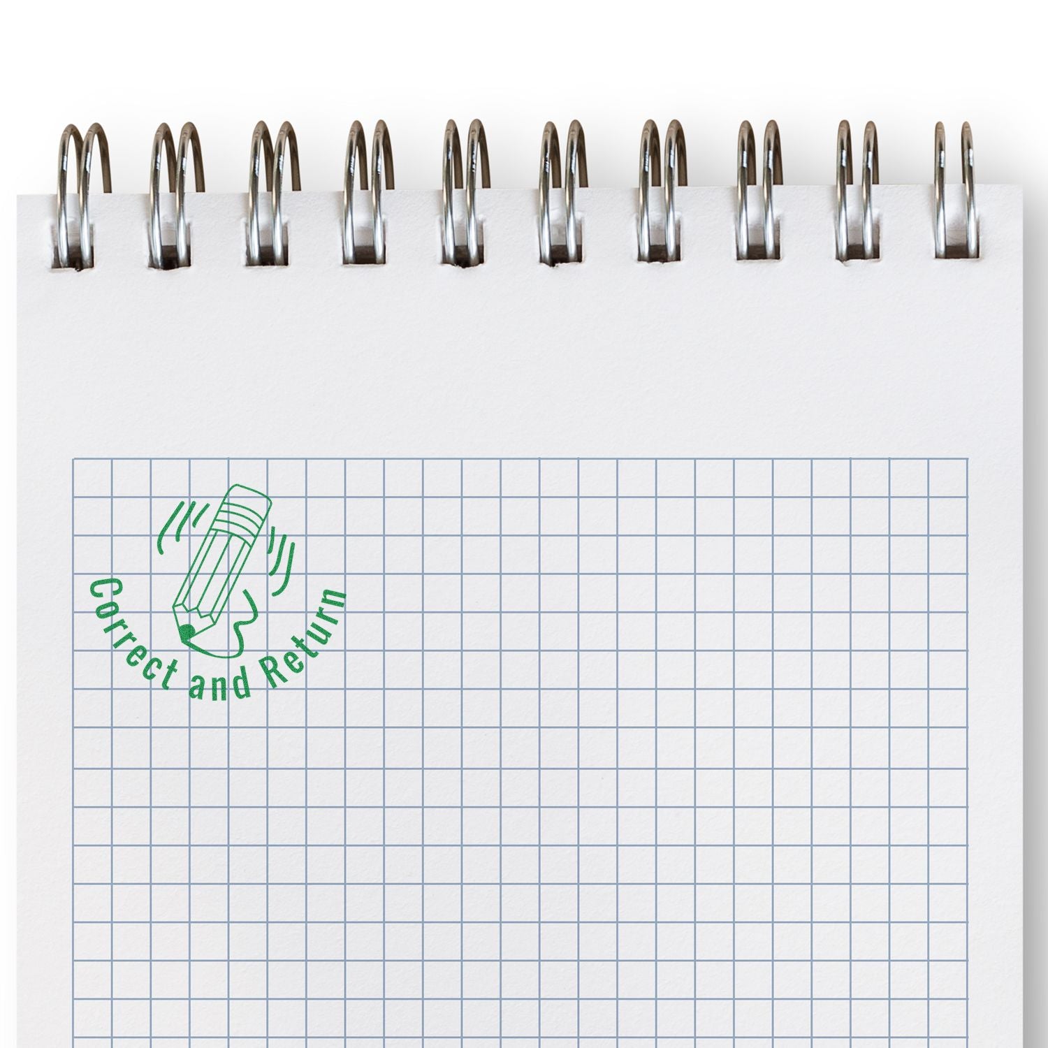 Spiral notebook with blank graph paper and green Correct and Return stamp on a clean white background.
