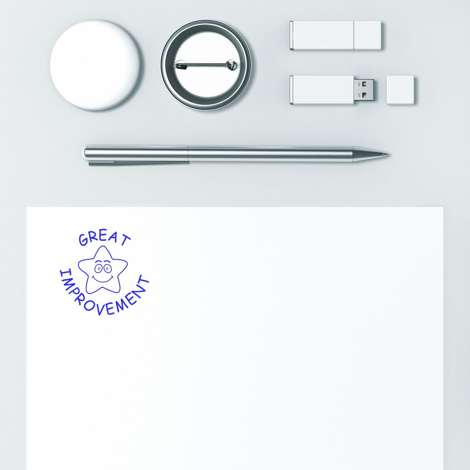 Minimalist branding mockup with pen, USB drive, badge buttons, and Great Improvement logo on white paper.