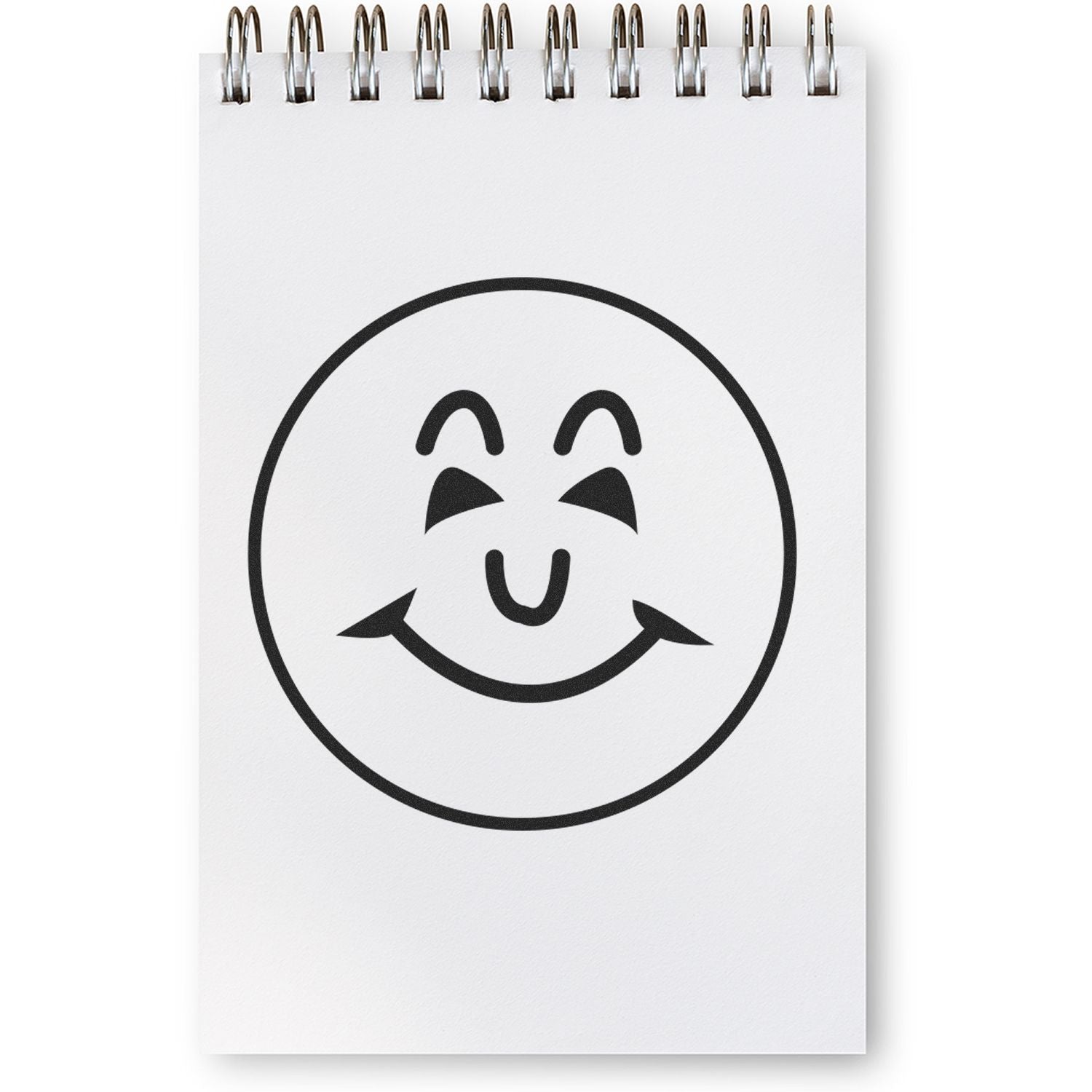 Minimalist spiral notebook with a smiling face doodle on a blank white page