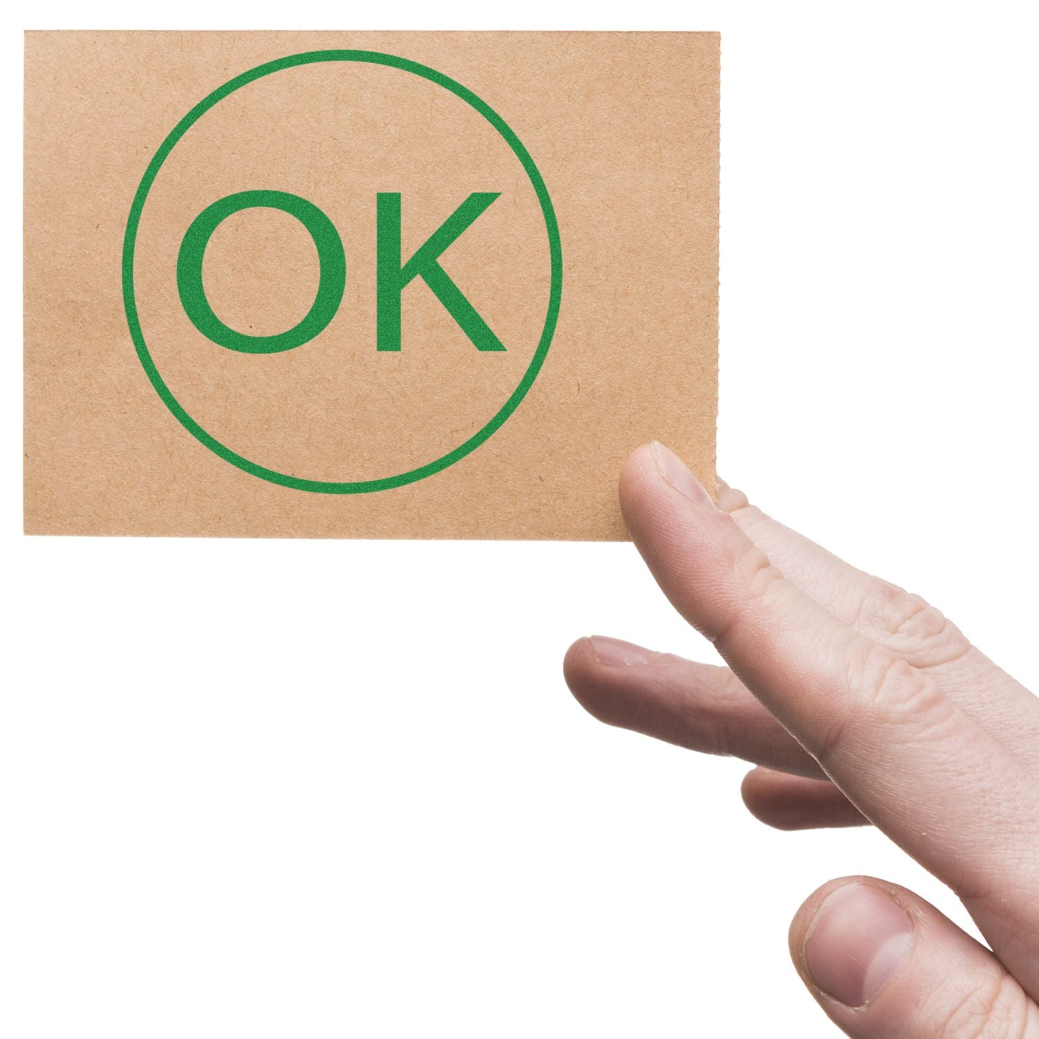 Hand holding a card with green OK approval symbol on a white background.