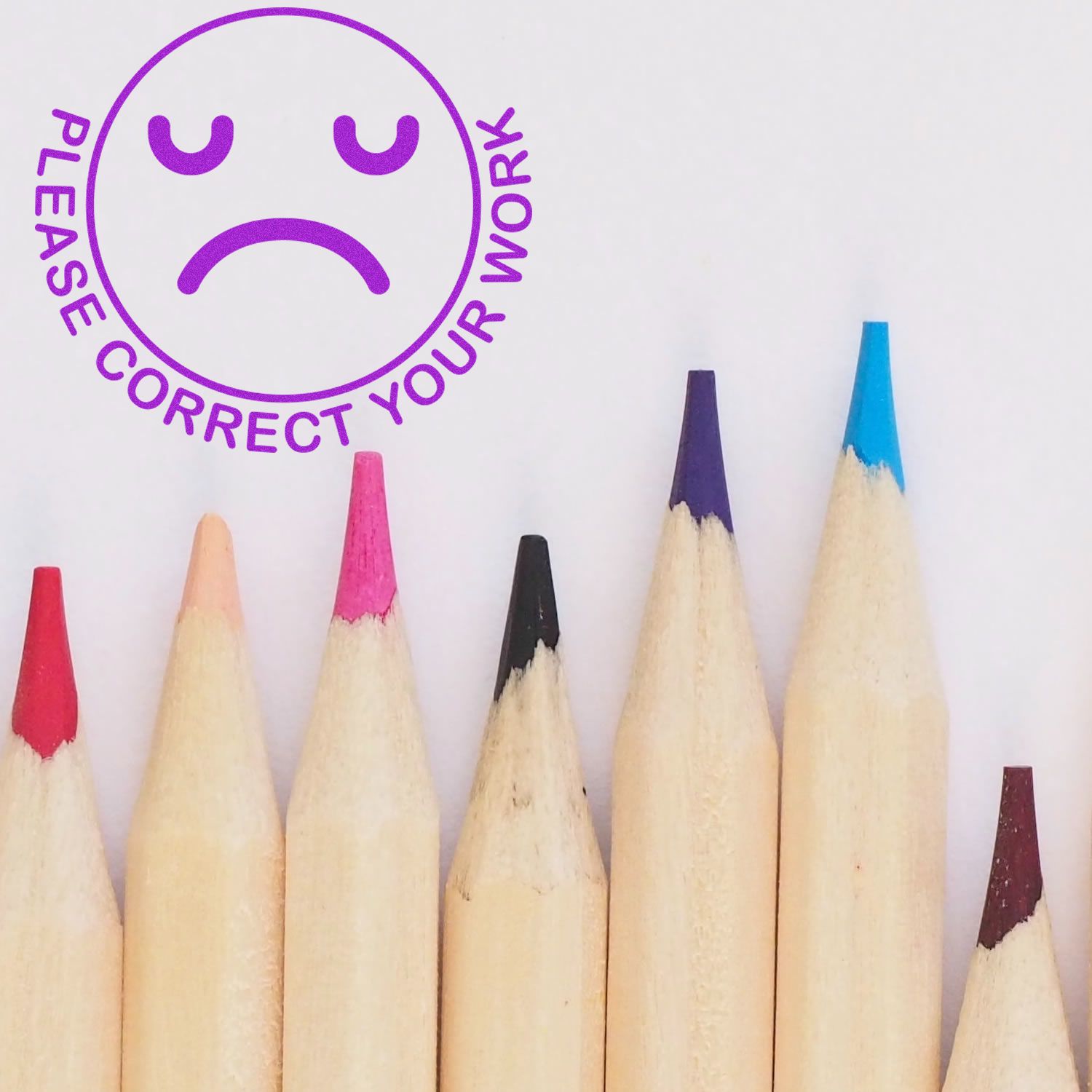 Colored pencil tips with a sad face icon and the text Please correct your work on a white background.