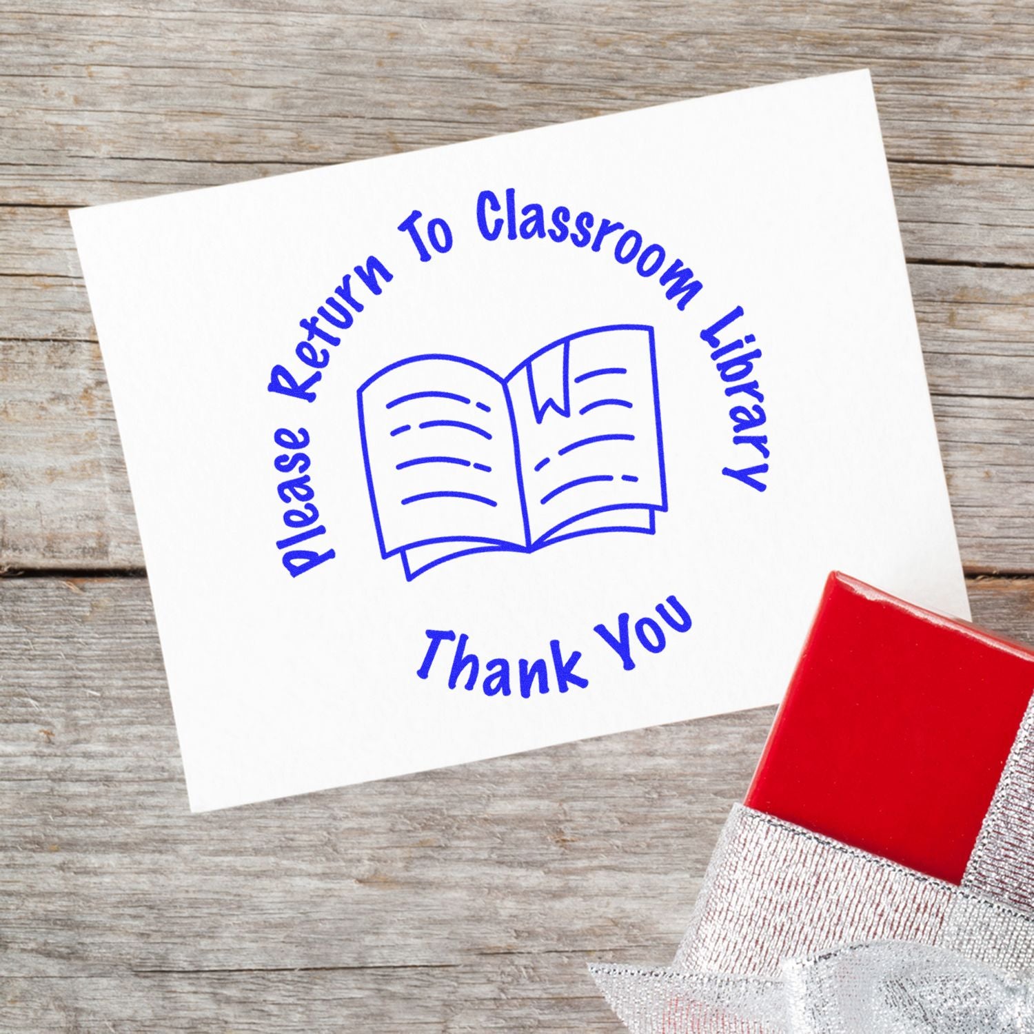 Please Return to Classroom Library sign with book icon and Thank You text on a rustic wood background, ideal for school library organization.