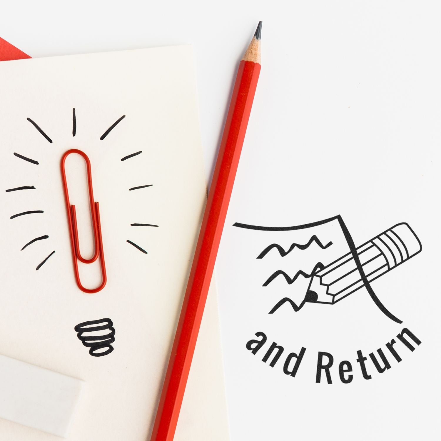 Red pencil on white paper with paperclip light bulb doodle and and Return stationery illustration concept.