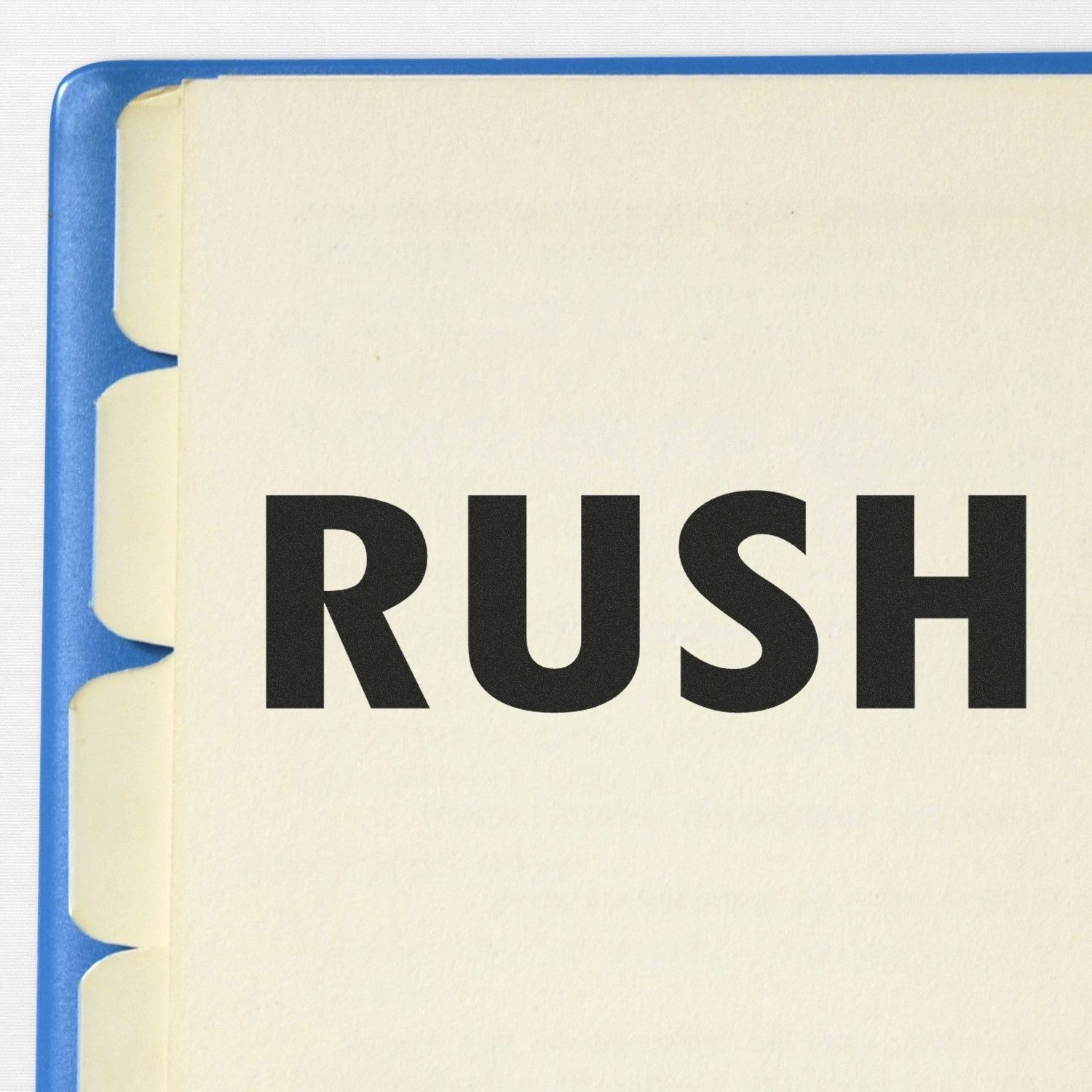 Close-up of a blue notebook cover with the word RUSH in bold black letters.