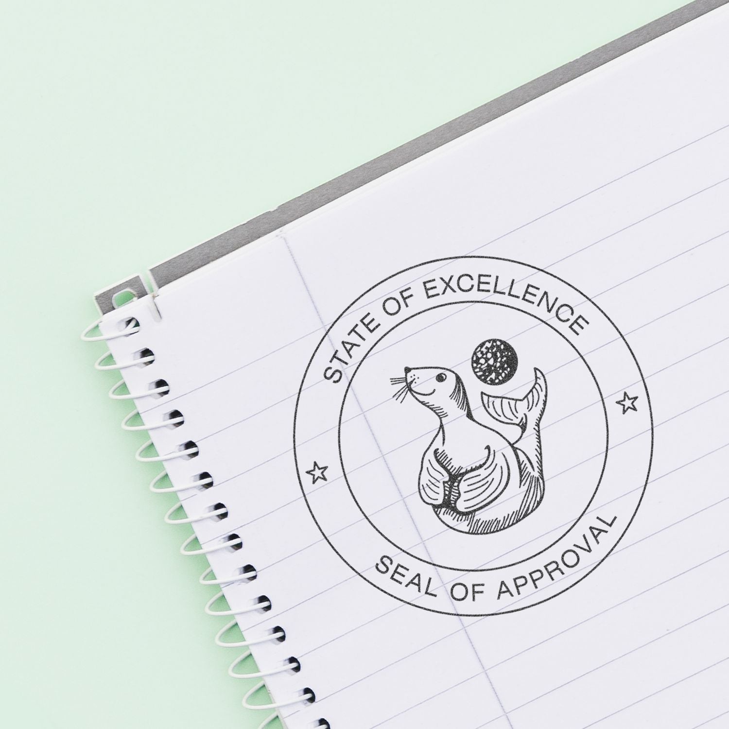 Spiral notebook with state of excellence seal of approval stamp on pastel background