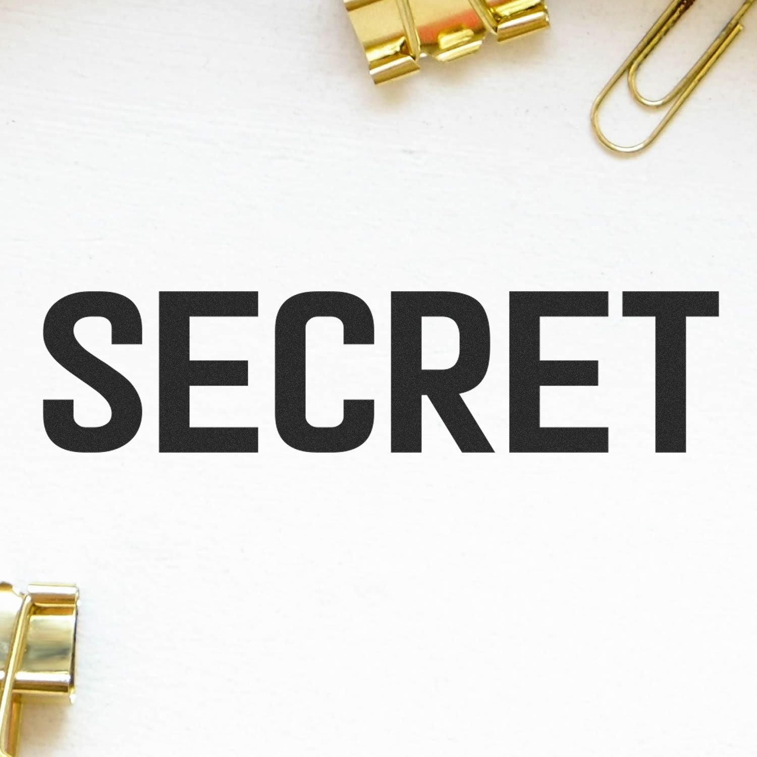 Secret text on white paper with gold paper clips, minimalist office or confidential document concept.