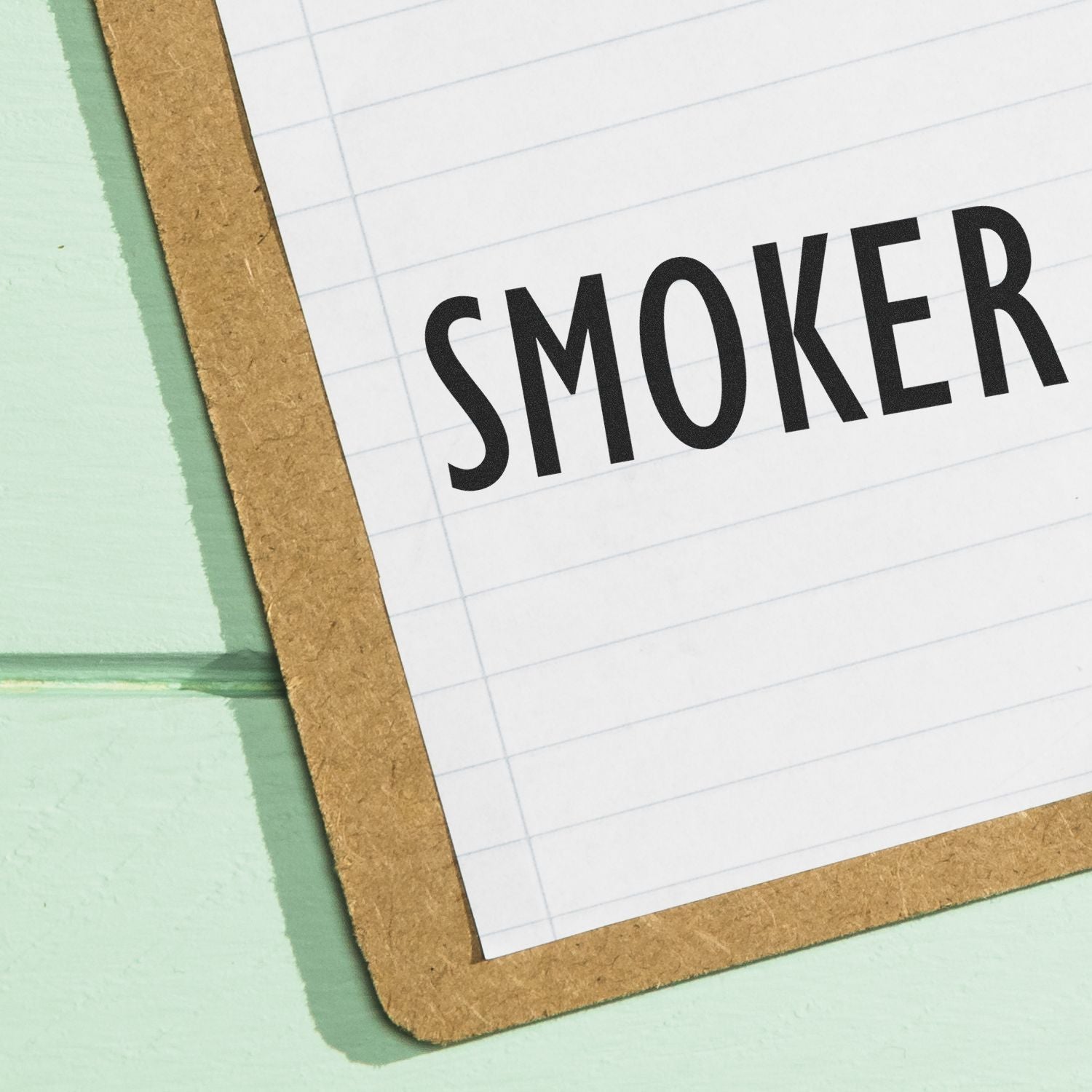 Notebook page with bold SMOKER text, emphasizing tobacco use status and smoking awareness context.