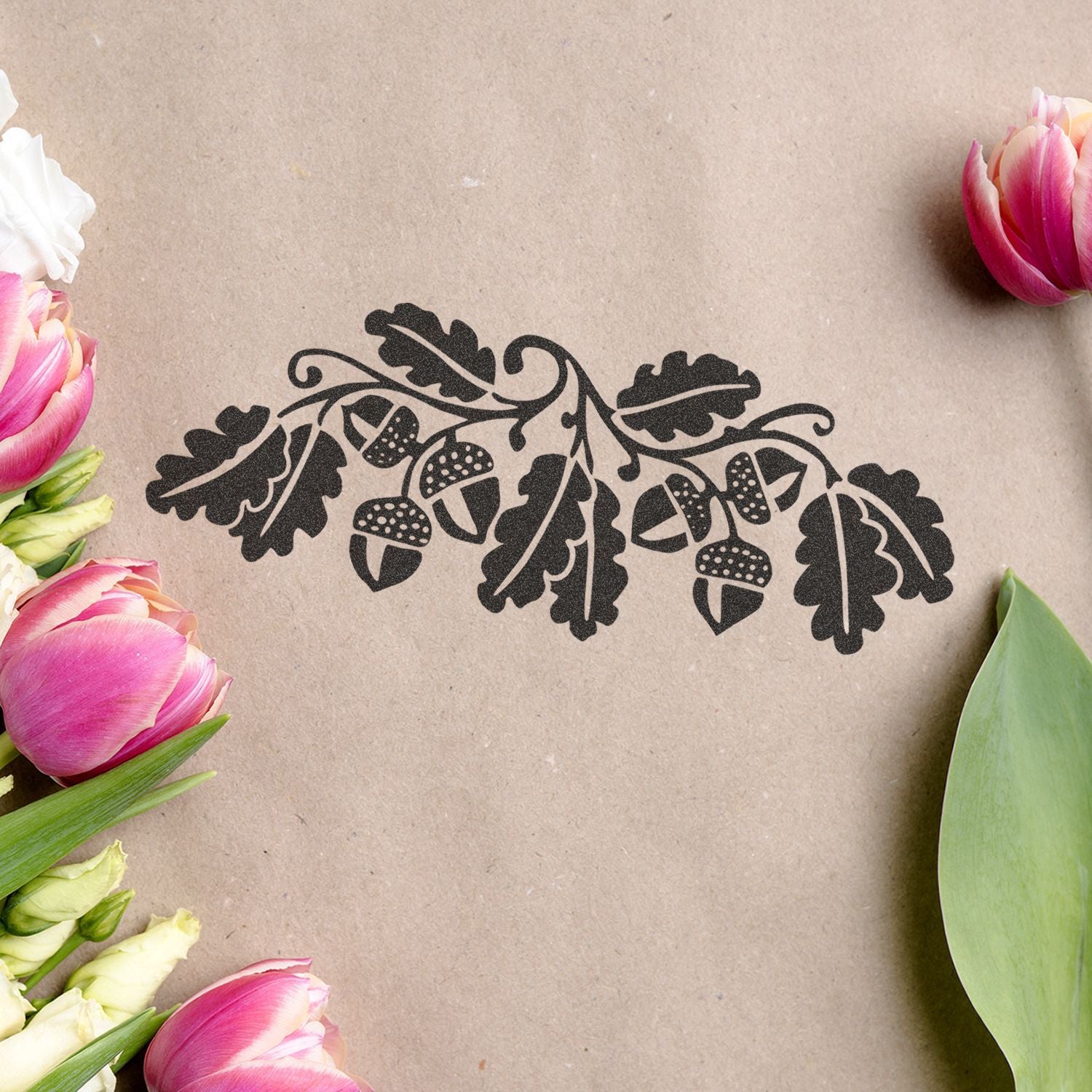 Black oak leaf and acorn floral design on kraft paper with pink tulips around the edges, rustic autumn decoration artwork
