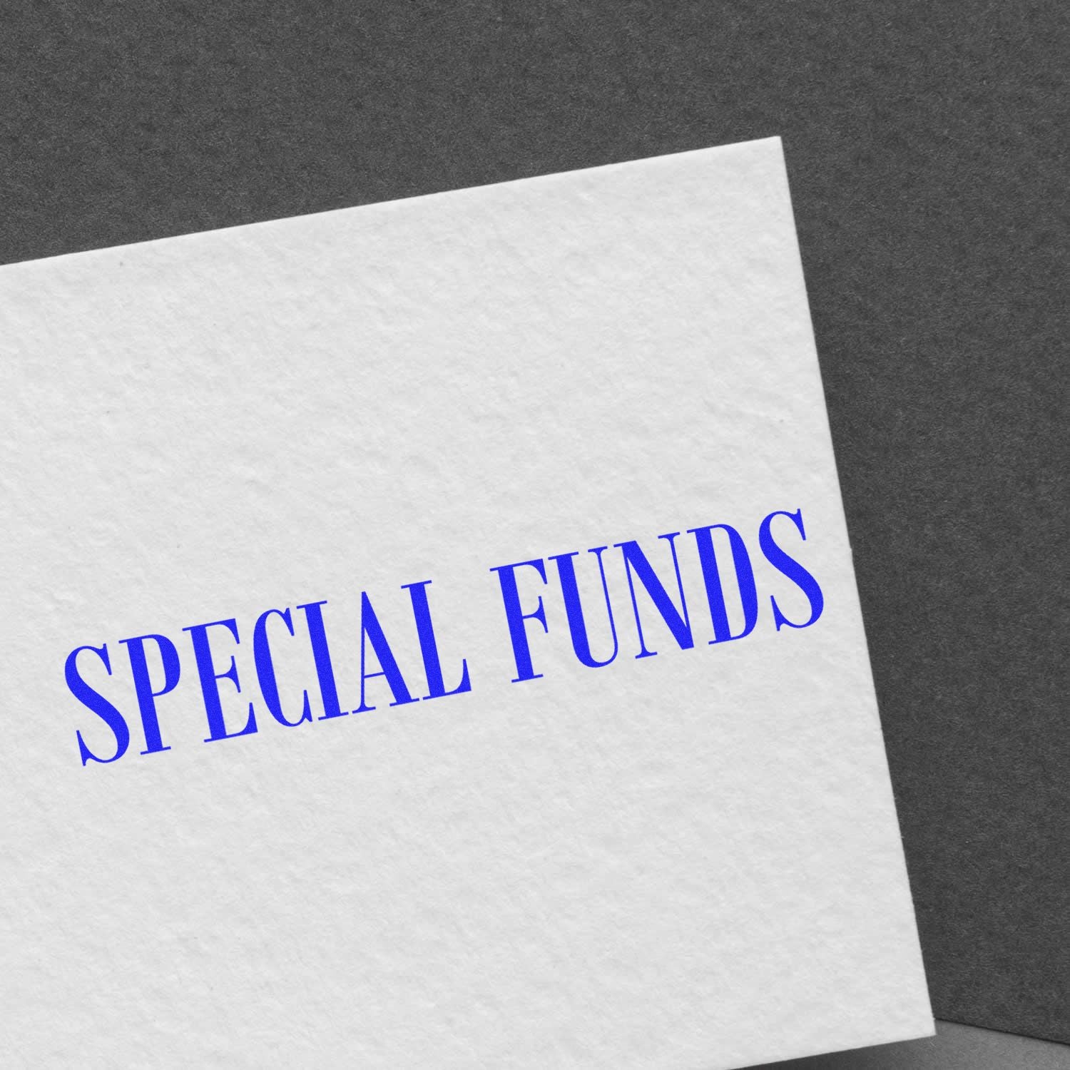 Close-up of a white document with blue Special Funds text on a dark background, concept for finance and funding.