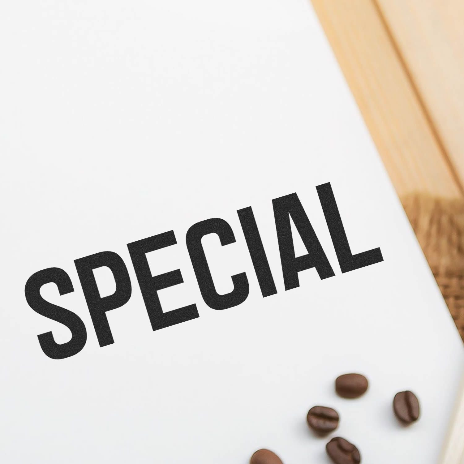 Special coffee beans on white packaging with wooden background