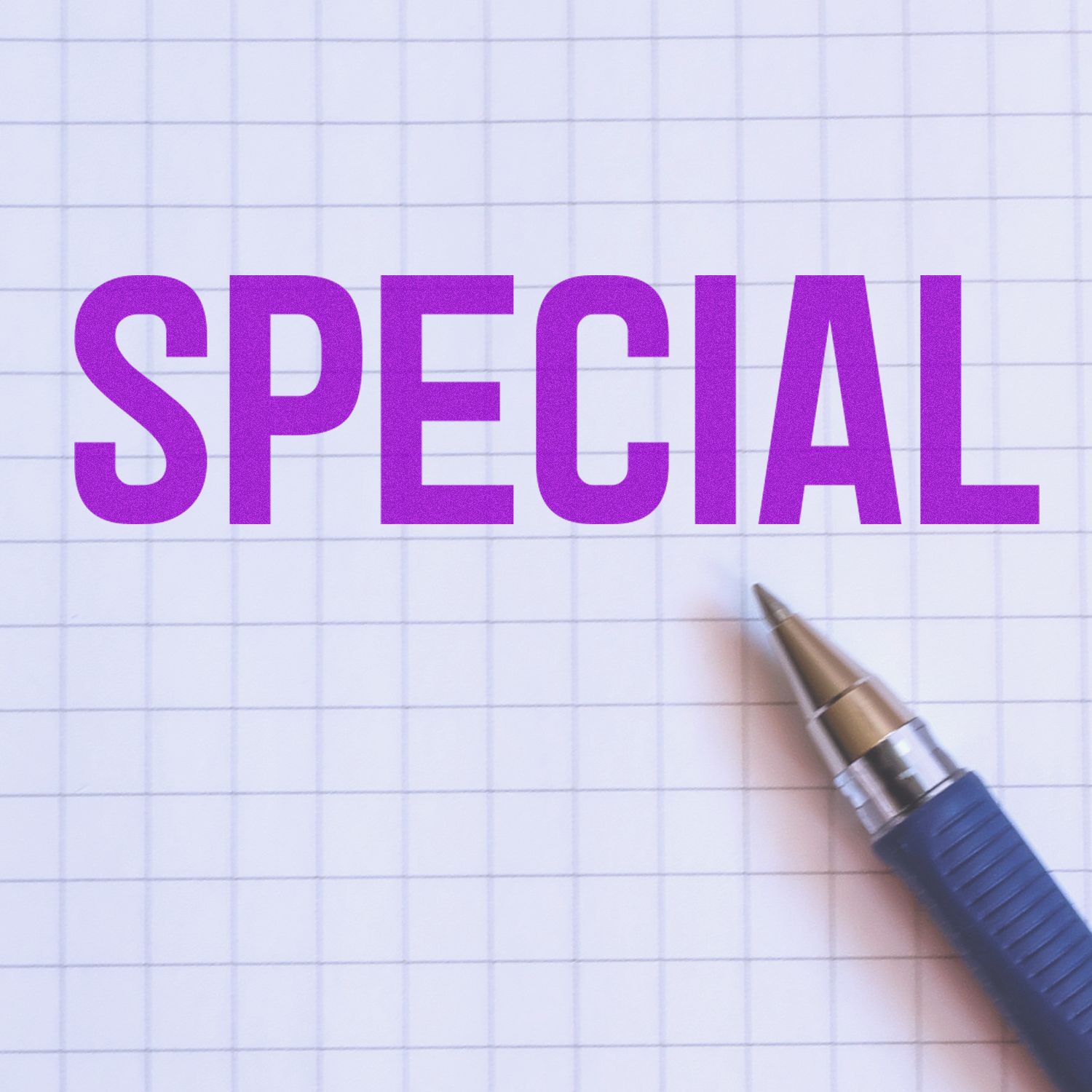 Purple SPECIAL text on graph paper with a pen, creative stationery concept.
