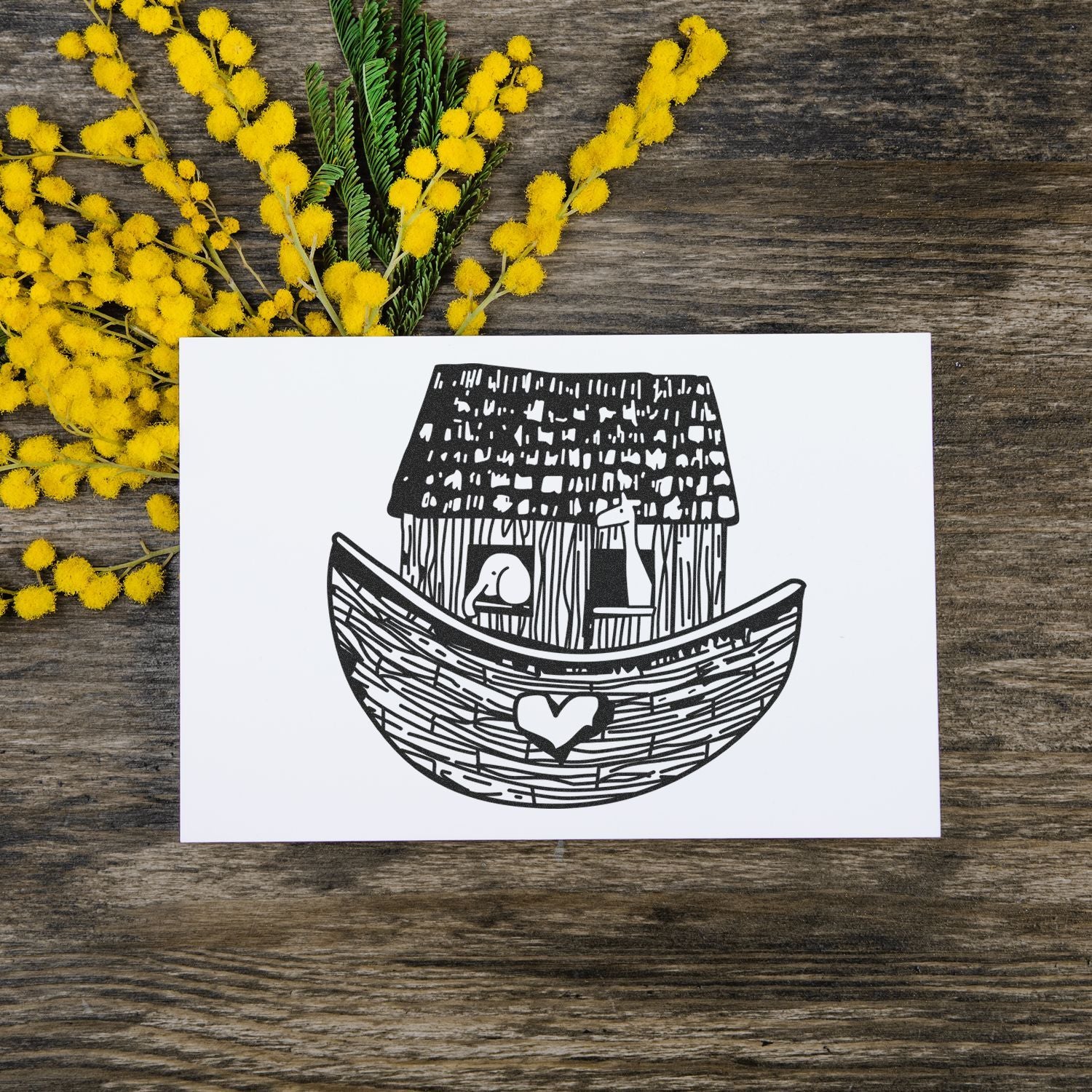 Noahs Ark line art card with yellow mimosa flowers on a rustic wooden background