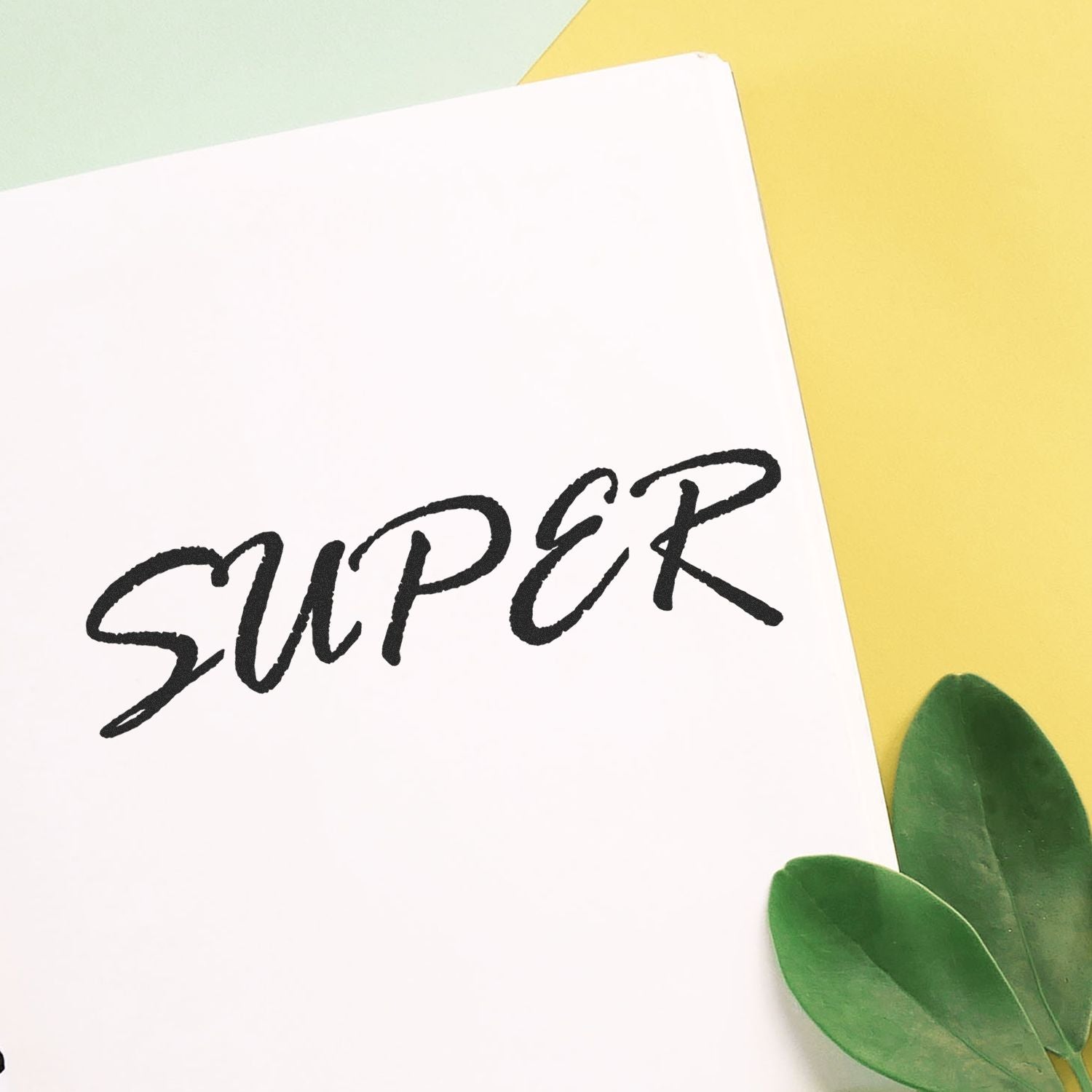 Minimal stationery card with handwritten wordmark and fresh green leaves background, ideal for brand greetings and invitations.