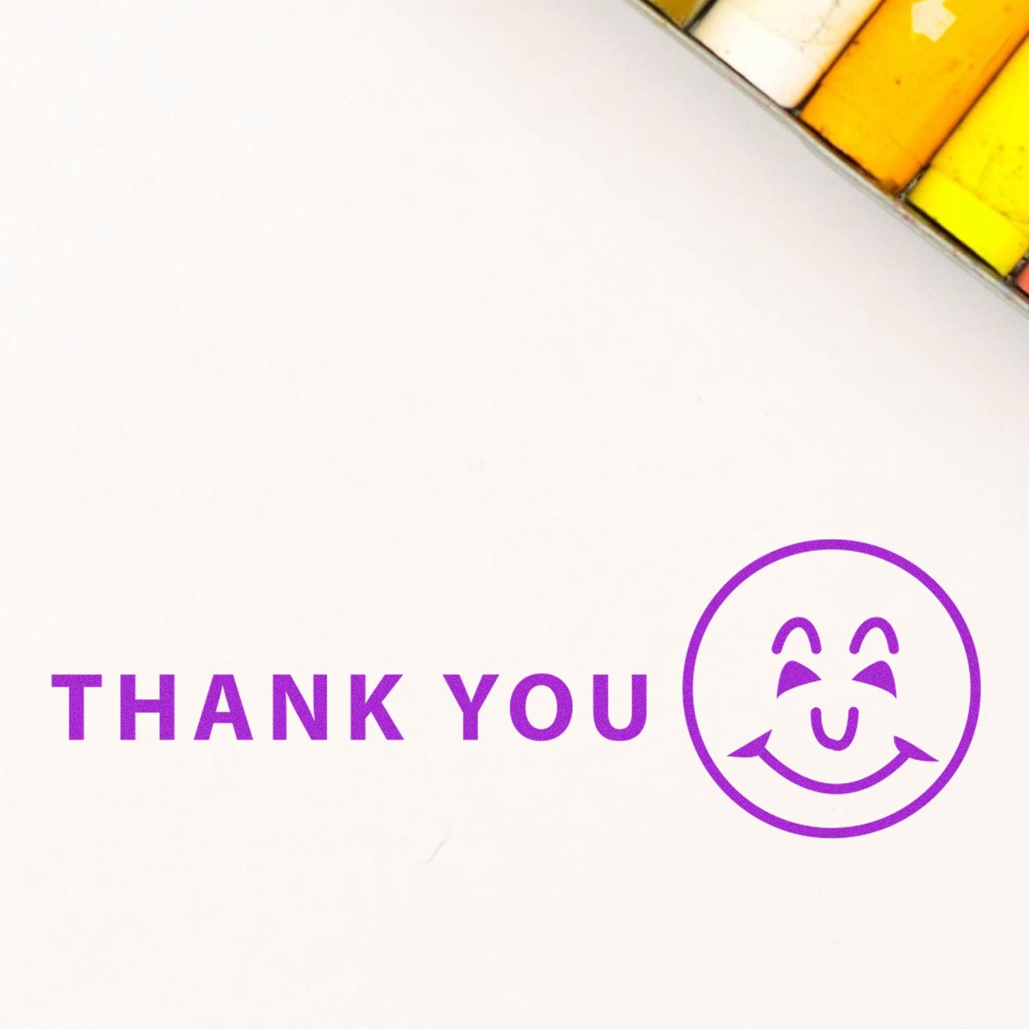 Purple Thank You text with a smiling face icon on a white background, ideal for a thank you card or greeting design.