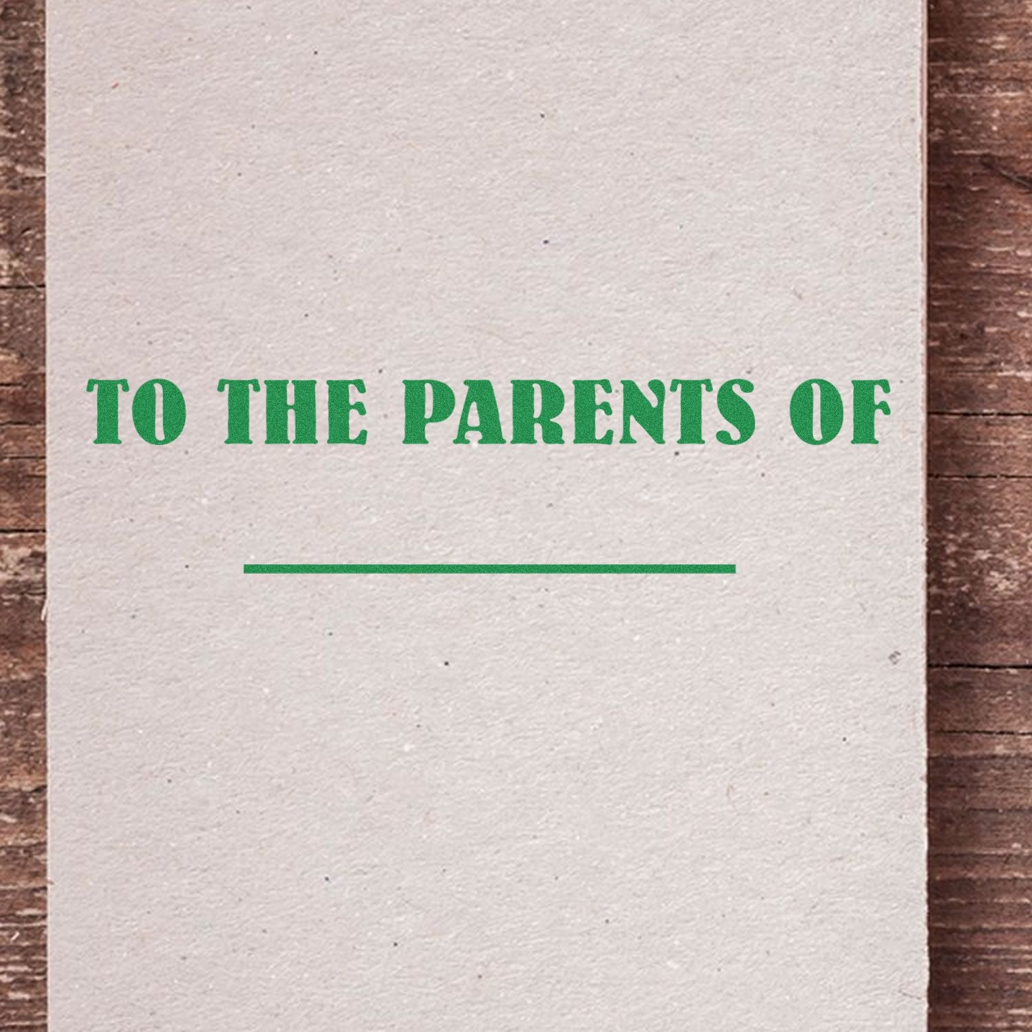 Vintage-style greeting card with green text reading To the Parents Of on textured paper background.